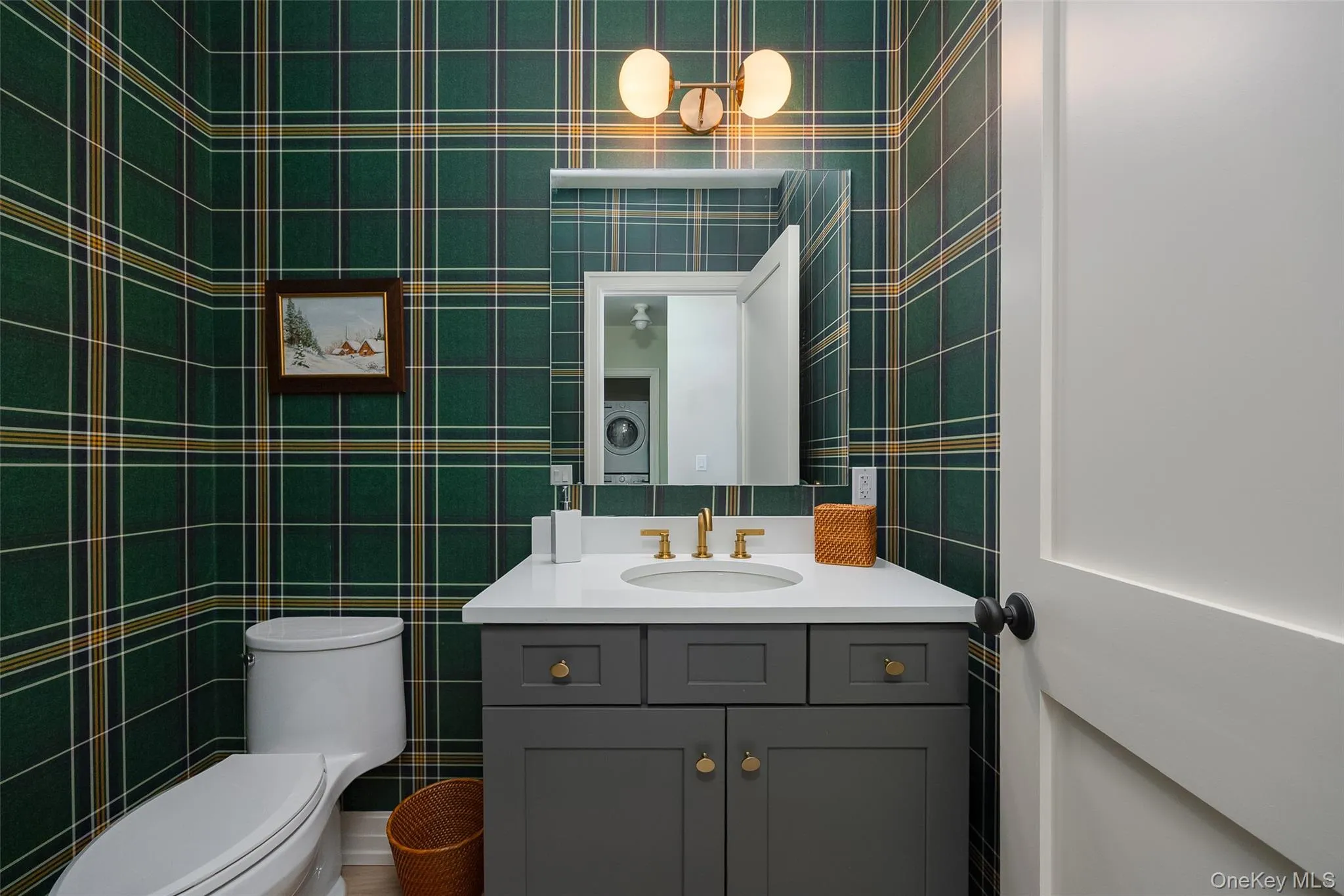 Bathroom featuring tile walls, vanity, and washer / dryer Bathroom featuring tile walls, vanity, and washer / dryer