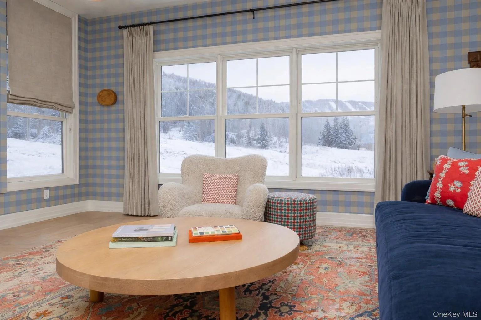 Sitting room with wallpapered walls, healthy amount of natural light, a mountain view, and wood finished floors Sitting room with wallpapered walls, healthy amount of natural light, a mountain view, and wood finished floors