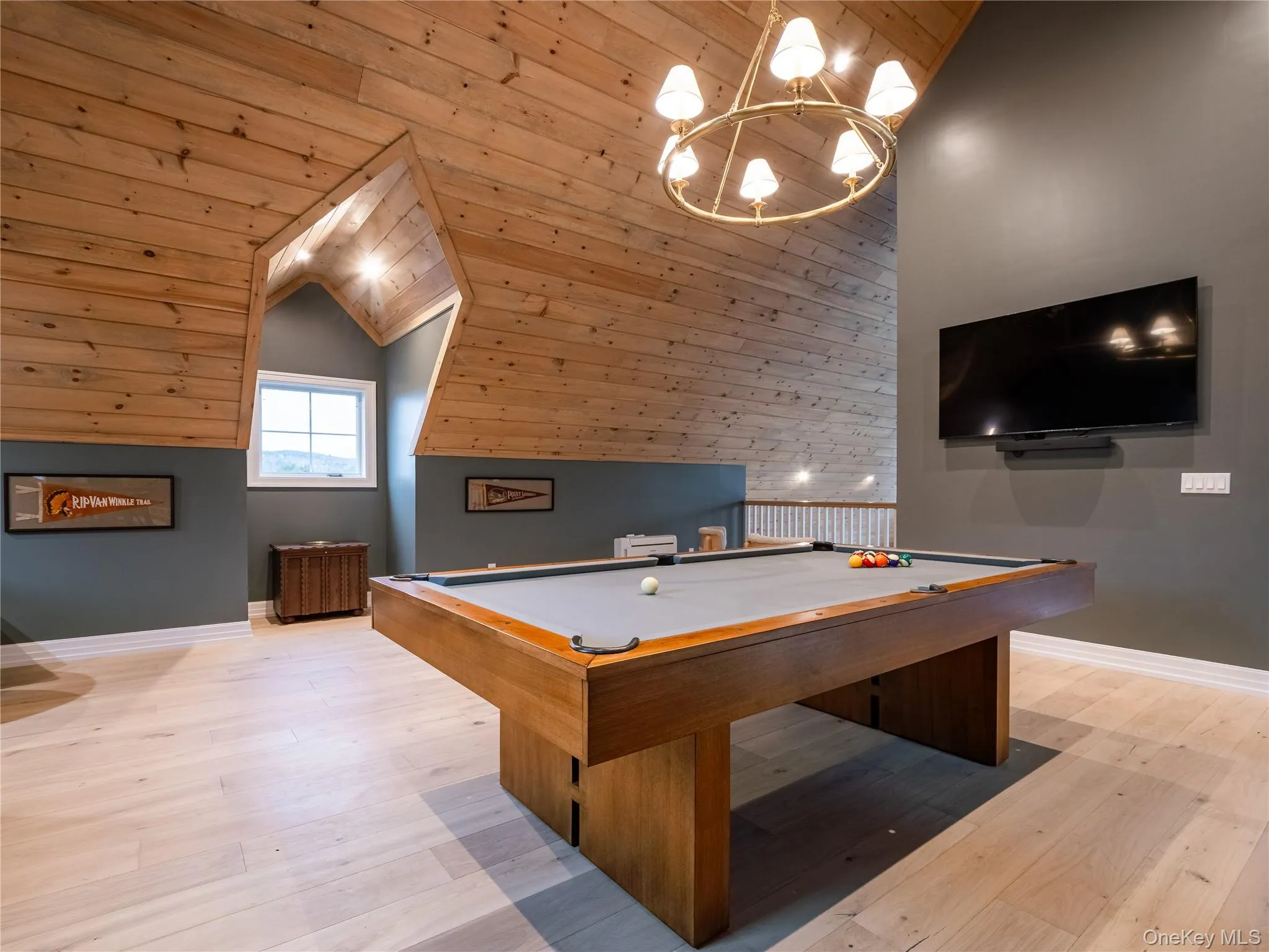 Game room featuring billiards table, light wood-style floors, wooden ceiling, lofted ceiling, and a chandelier Game room featuring billiards table, light wood-style floors, wooden ceiling, lofted ceiling, and a chandelier