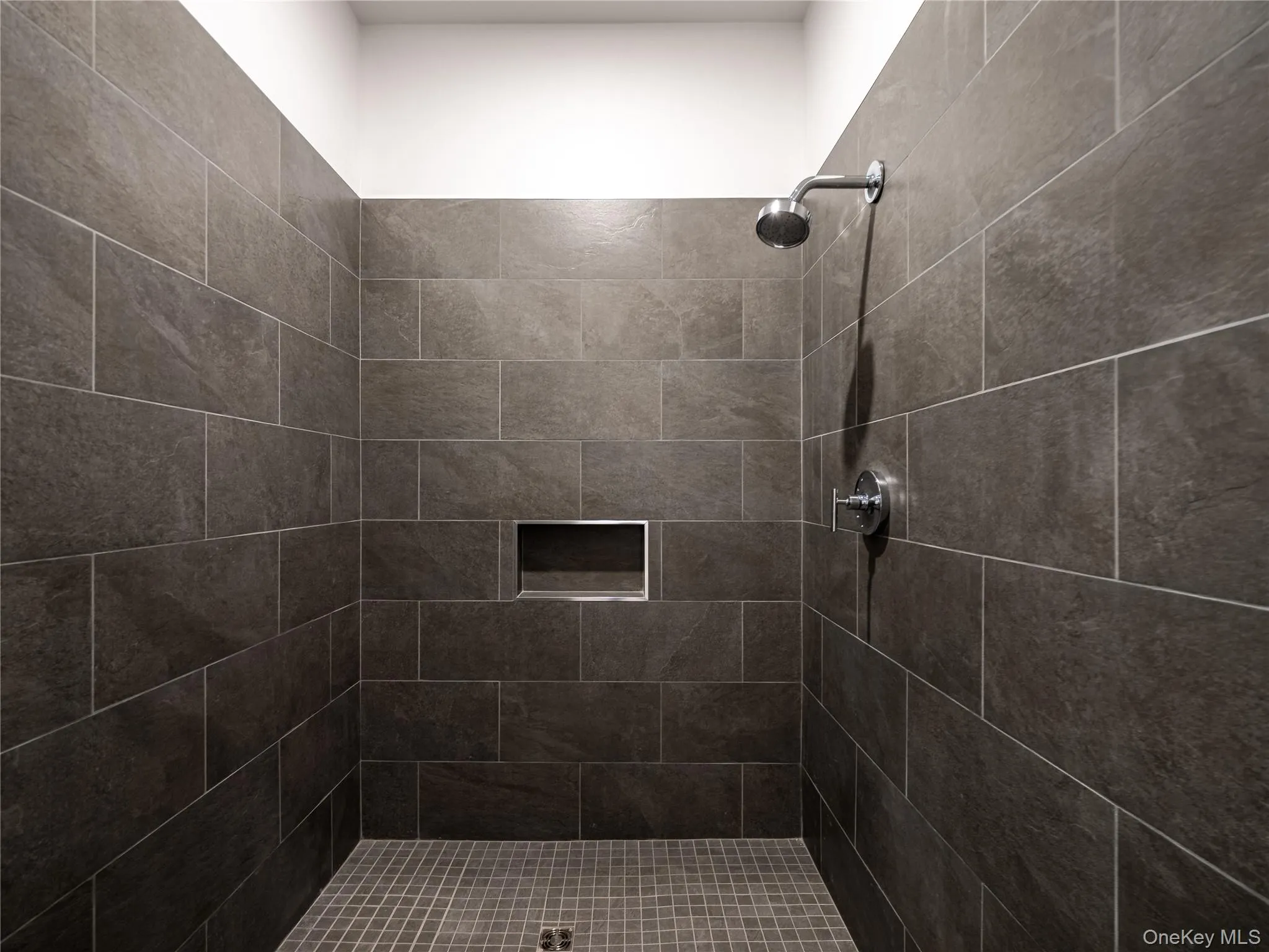 Full bathroom featuring tiled shower Full bathroom featuring tiled shower