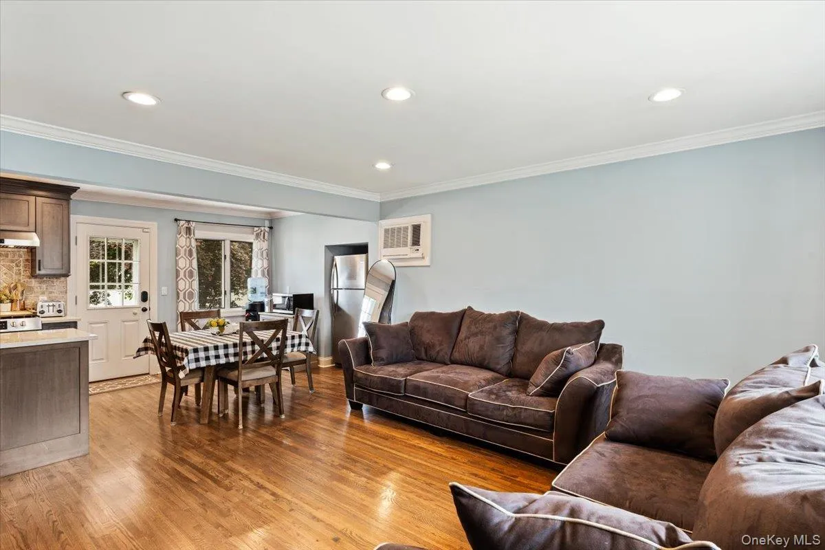 Hardwood flooring, recessed lighting, crown molding, double-pane window, and a built-in kitchen Hardwood flooring, recessed lighting, crown molding, double-pane window, and a built-in kitchen