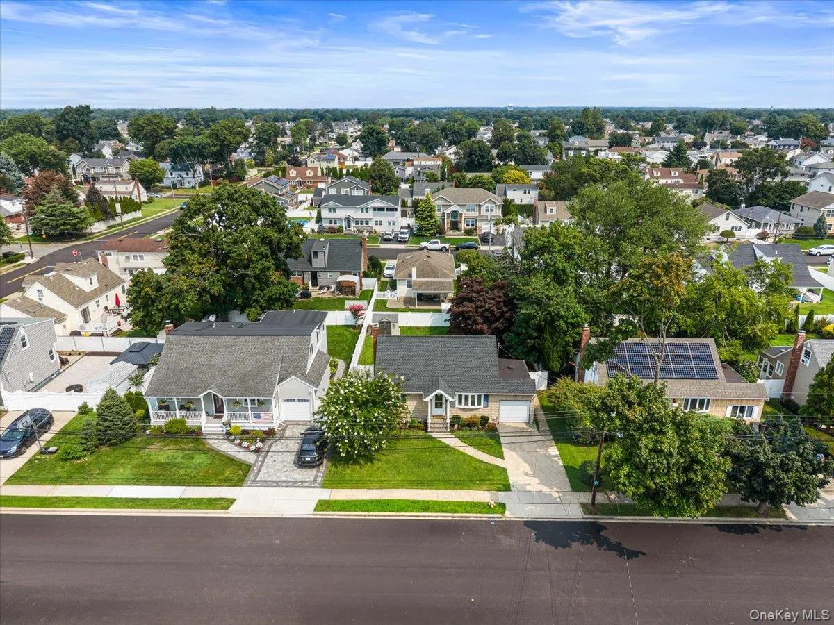 Expansive neighborhood with mature trees, residential properties, and paved streets Expansive neighborhood with mature trees, residential properties, and paved streets