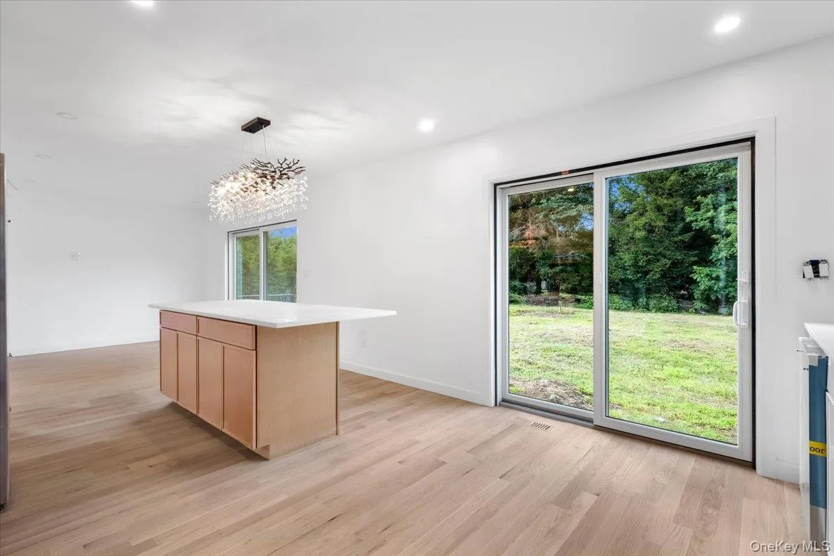 Kitchen island & view of backyard with sliding glass door to yard Kitchen island & view of backyard with sliding glass door to yard