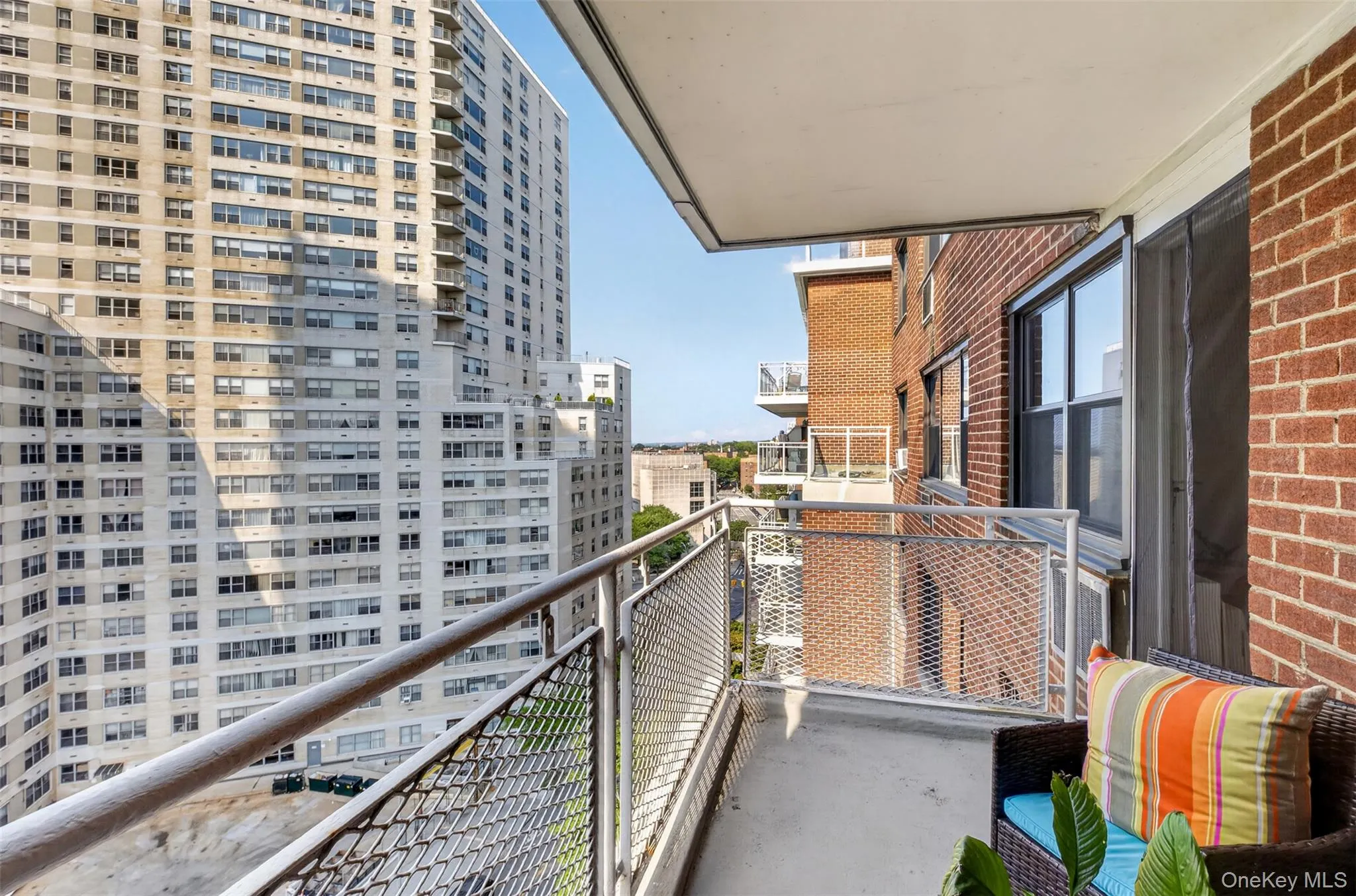 Concrete balcony with metal railing, brick exterior, and sliding glass door Concrete balcony with metal railing, brick exterior, and sliding glass door