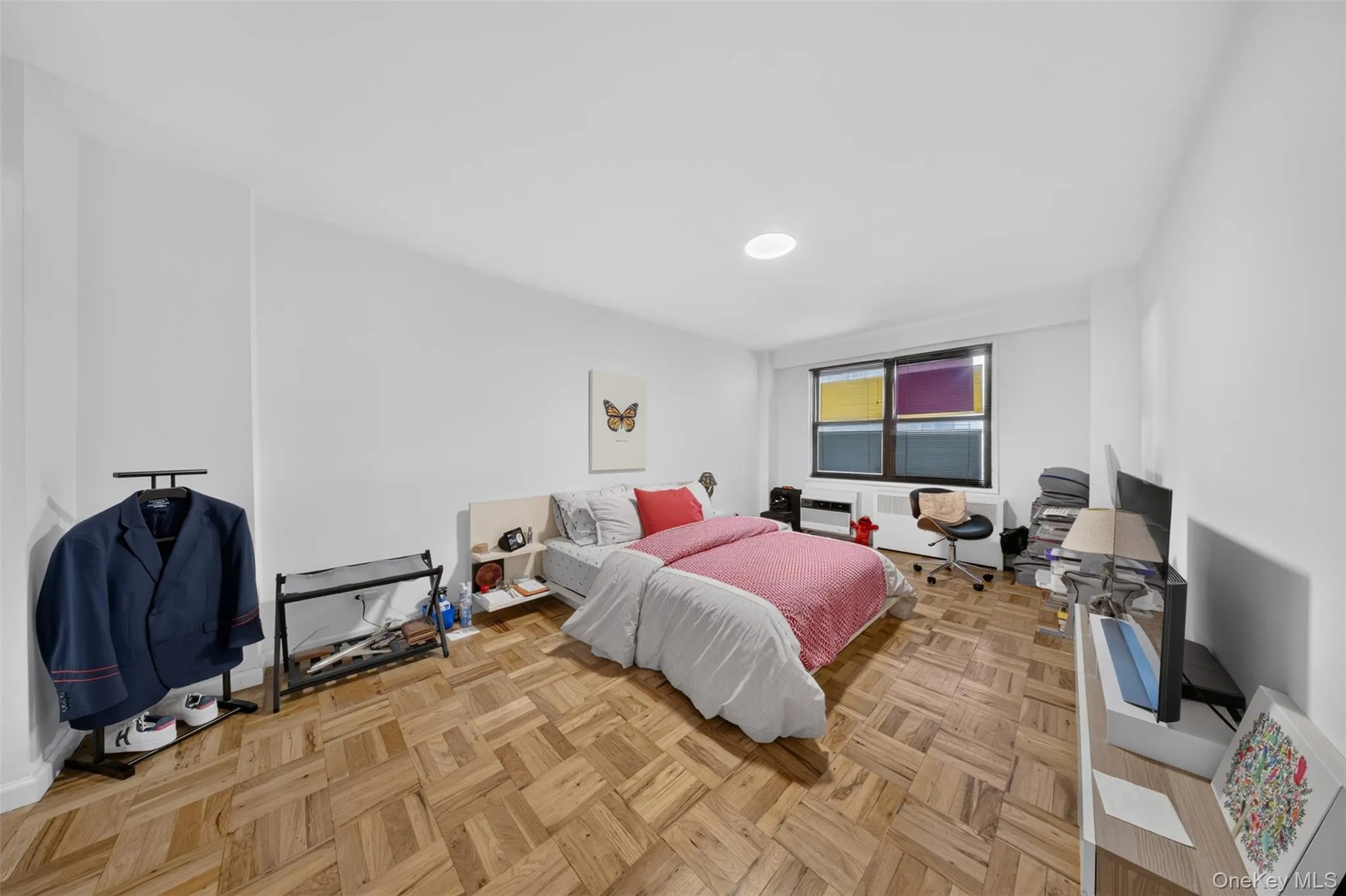 Parquet wood-finish flooring, recessed ceiling lighting, wall-mounted air conditioning unit, and a window with a built-in heating element Parquet wood-finish flooring, recessed ceiling lighting, wall-mounted air conditioning unit, and a window with a built-in heating element