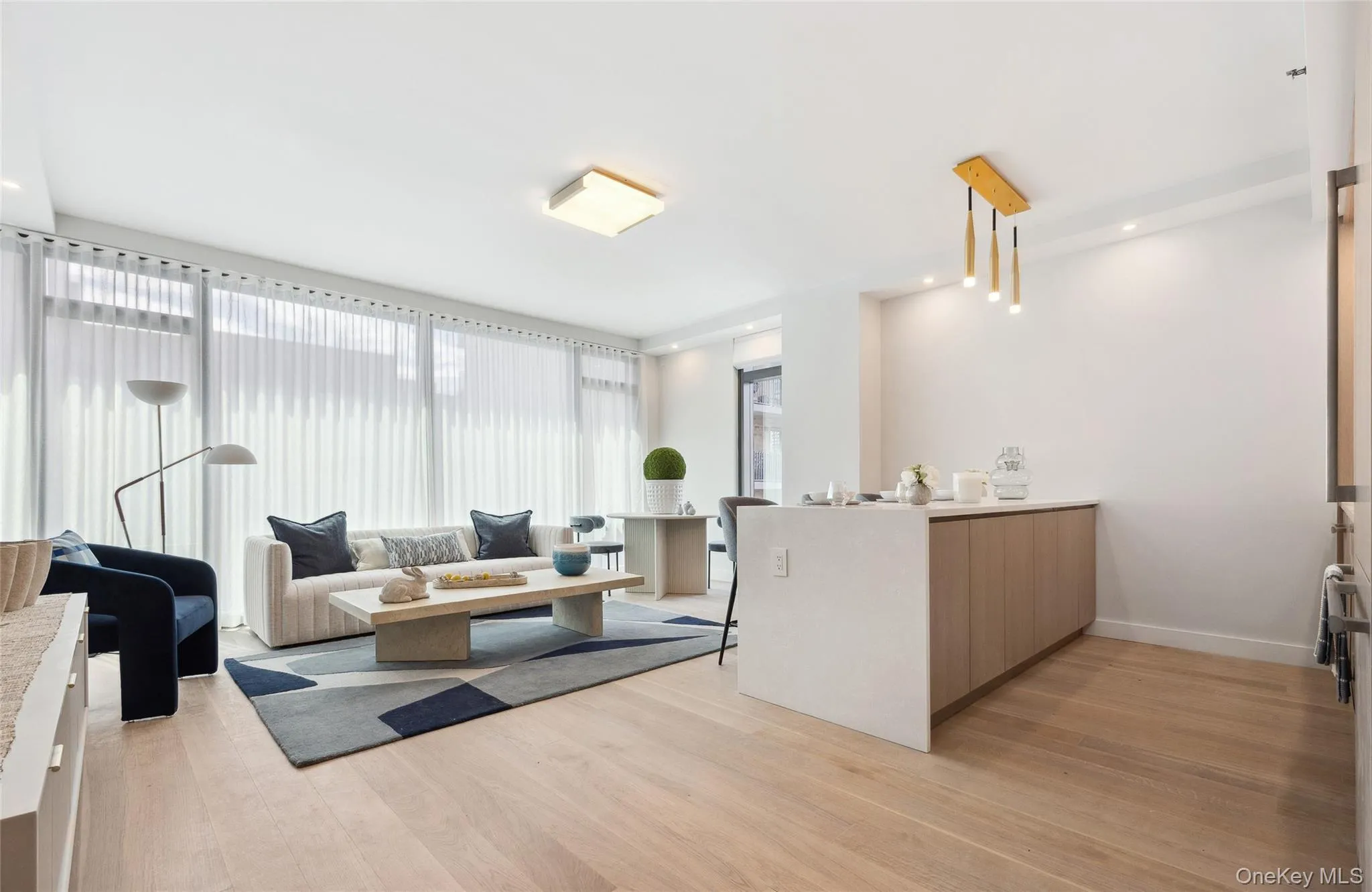 Living area featuring light wood-style floors and baseboards Living area featuring light wood-style floors and baseboards