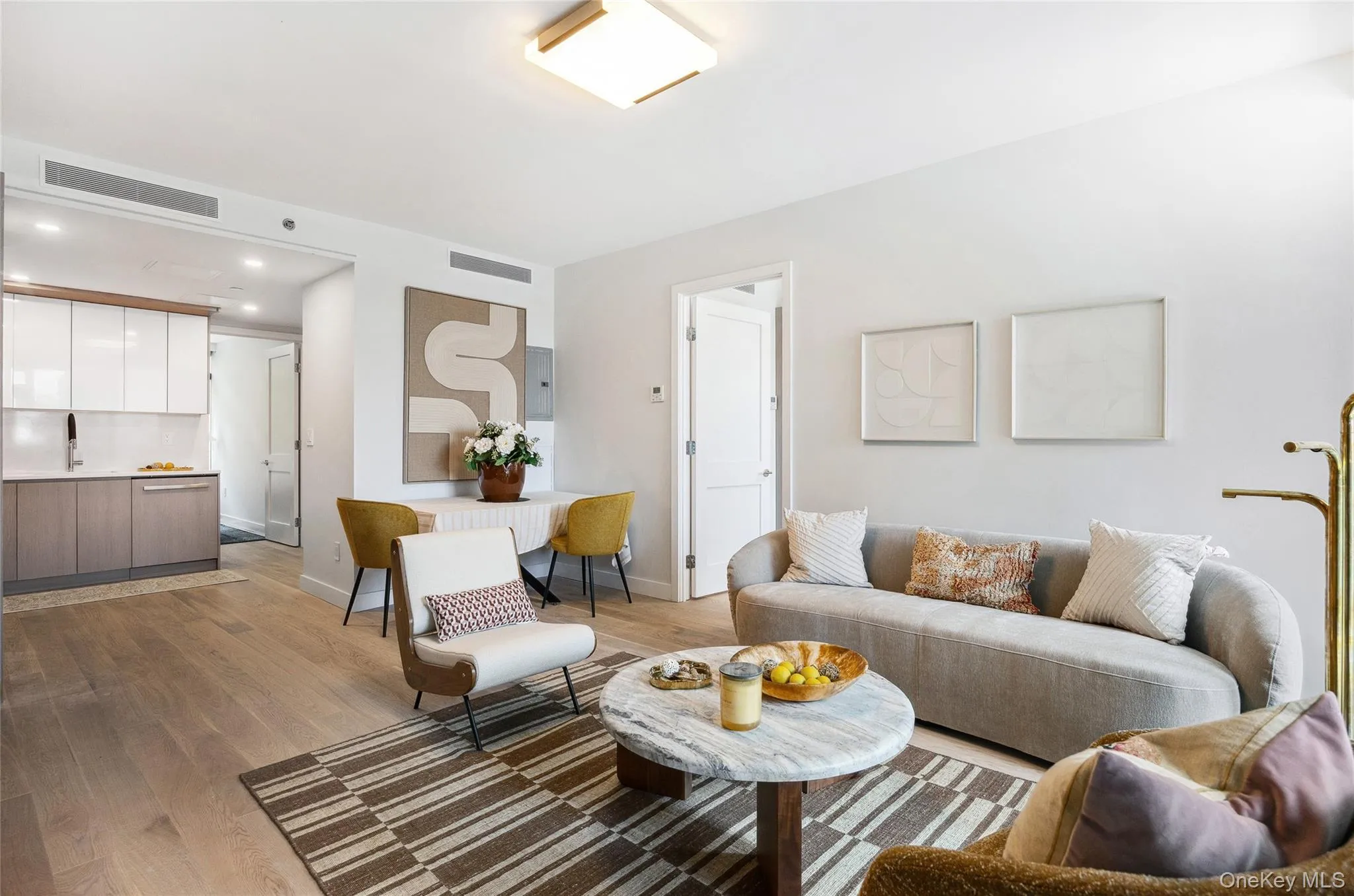 Living room featuring light wood finished floors, baseboards, and recessed lighting Living room featuring light wood finished floors, baseboards, and recessed lighting