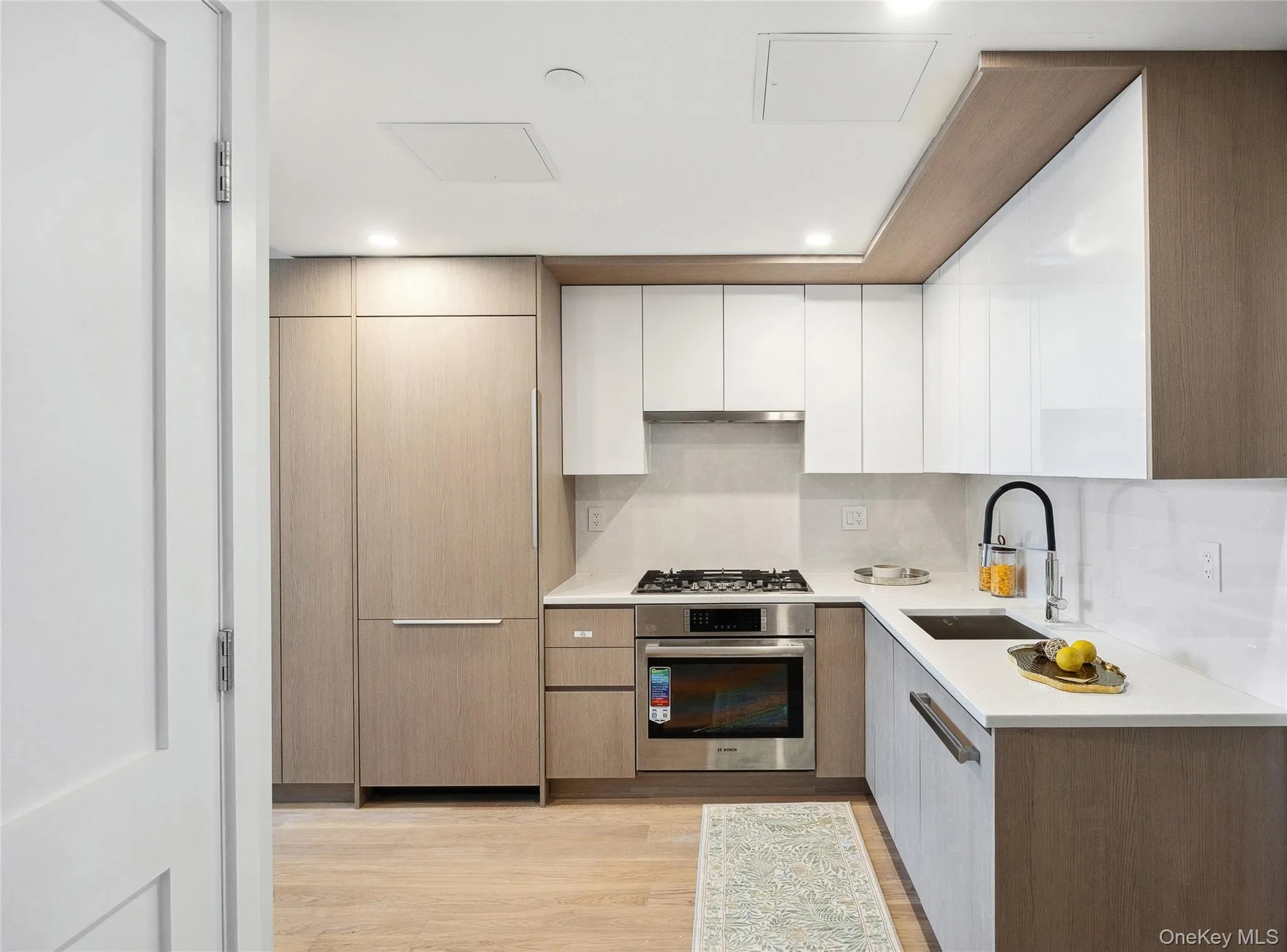 Kitchen with appliances with stainless steel finishes, a sink, modern cabinets, and recessed lighting Kitchen with appliances with stainless steel finishes, a sink, modern cabinets, and recessed lighting