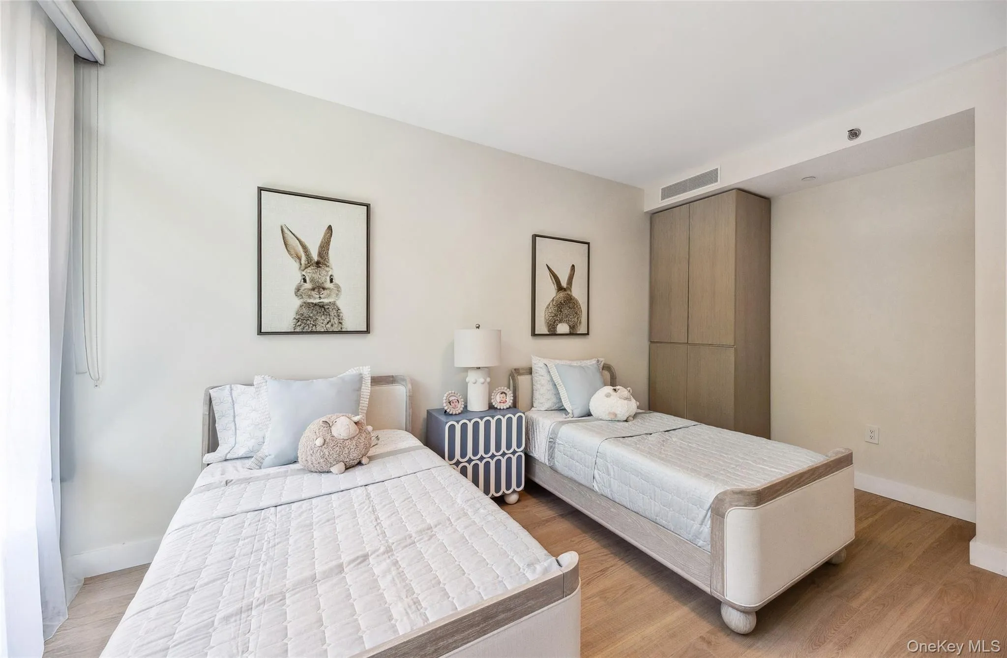 Bedroom featuring light wood-style floors and baseboards Bedroom featuring light wood-style floors and baseboards