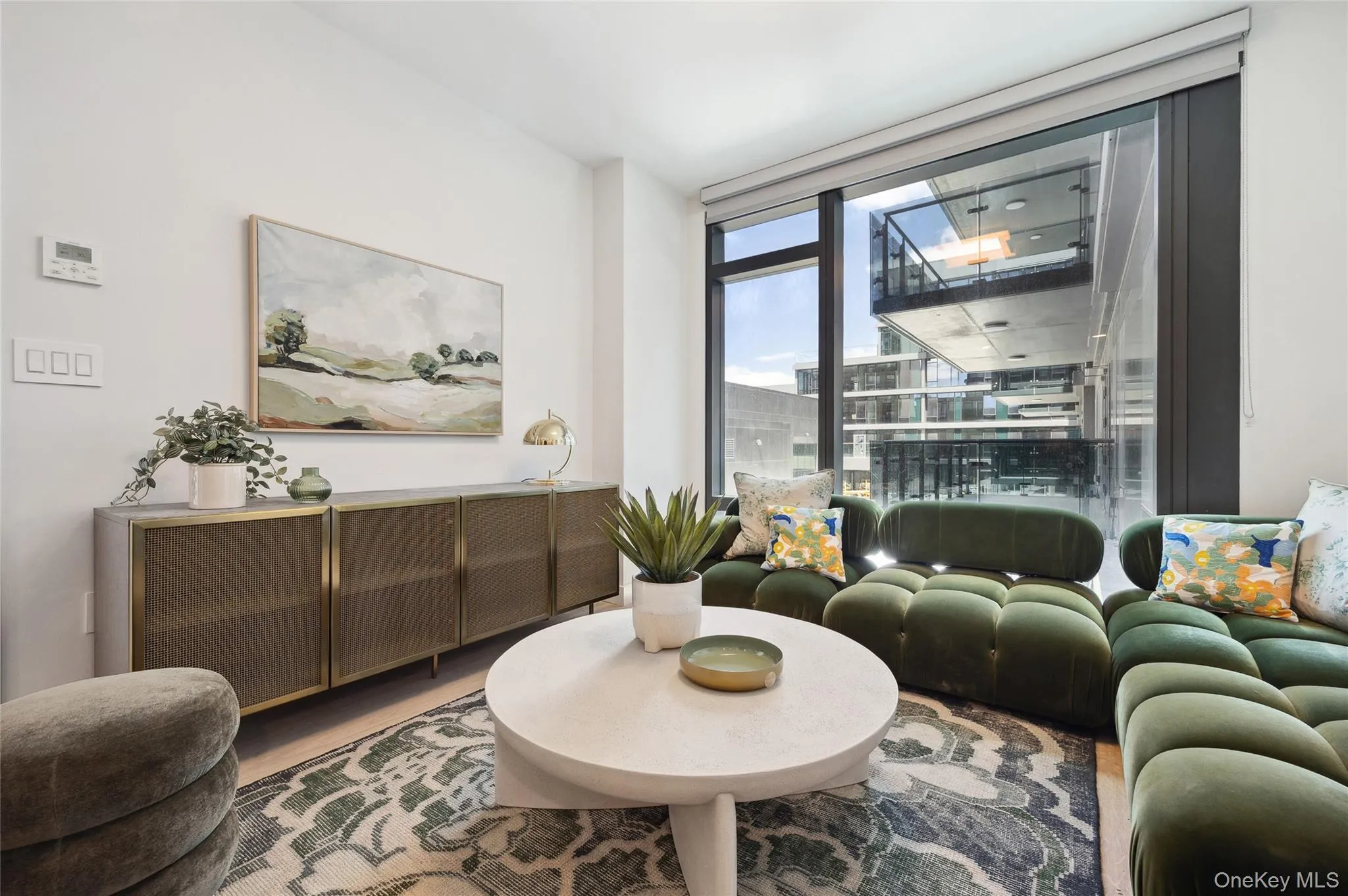 Living room with wood finished floors and floor to ceiling windows Living room with wood finished floors and floor to ceiling windows