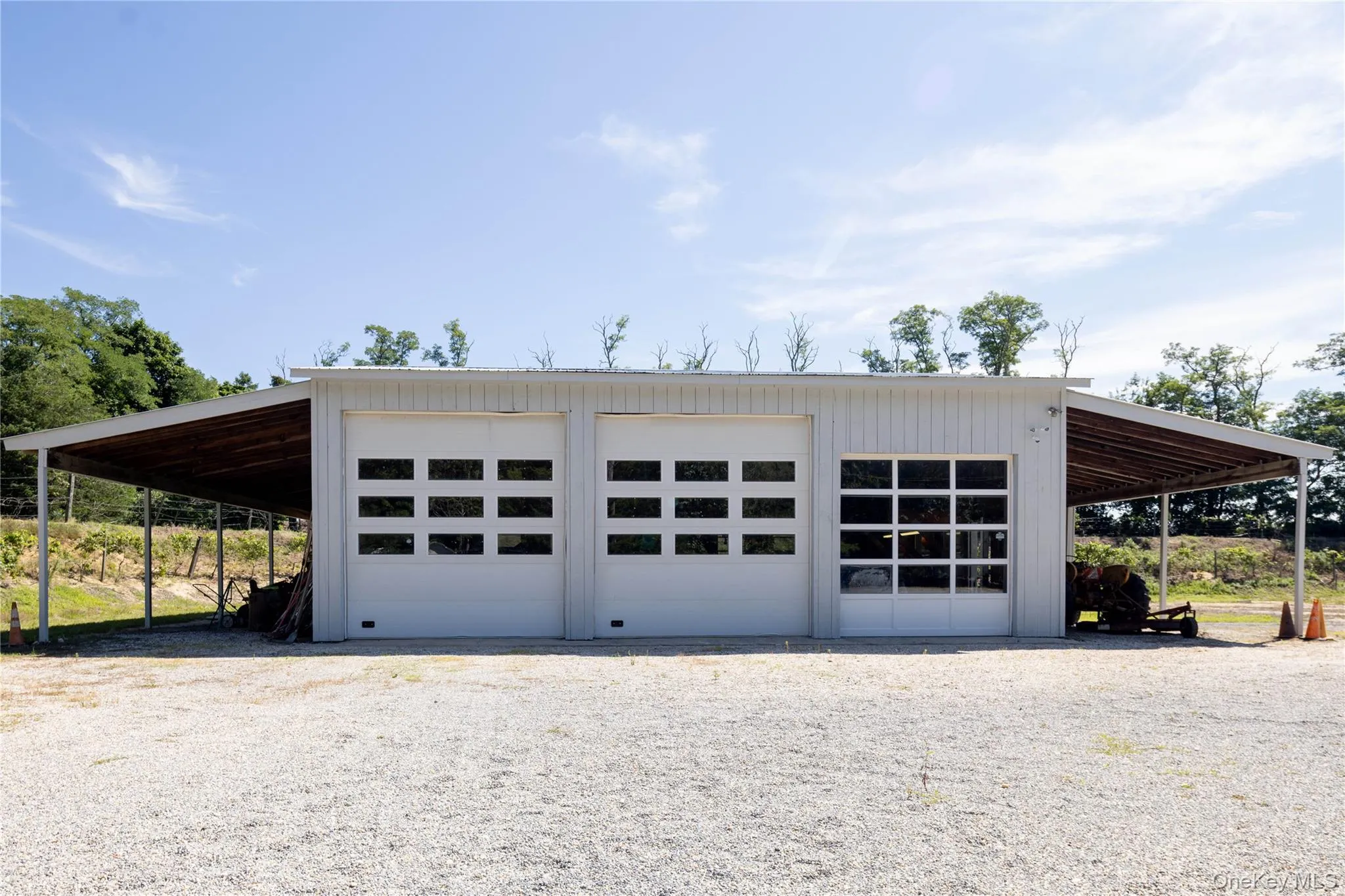 Exterior view of large garage structure with three 14' run-ins Exterior view of large garage structure with three 14' run-ins