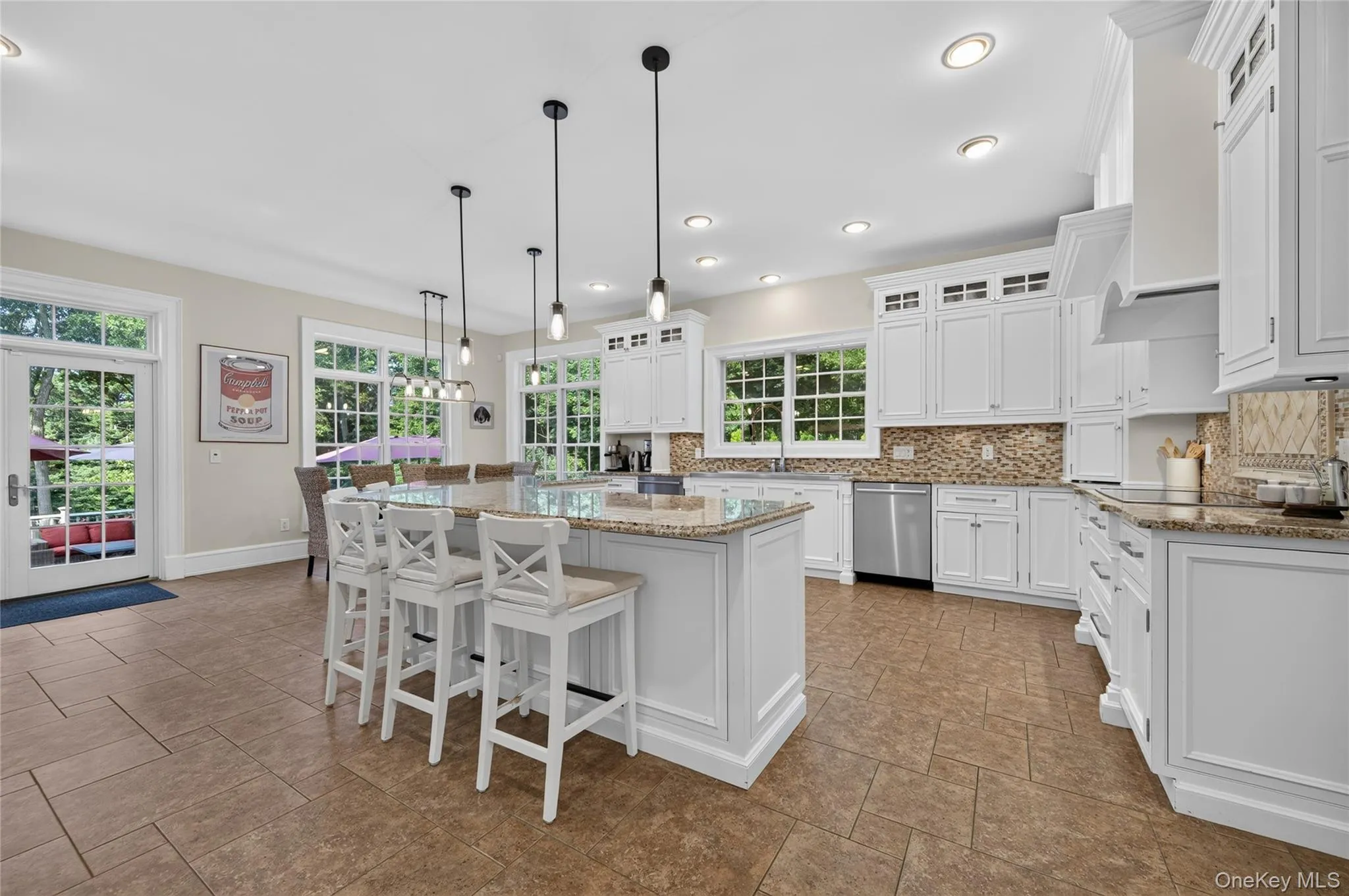 Kitchen w/access to backyard patios, fire pit, and heated pool Kitchen w/access to backyard patios, fire pit, and heated pool
