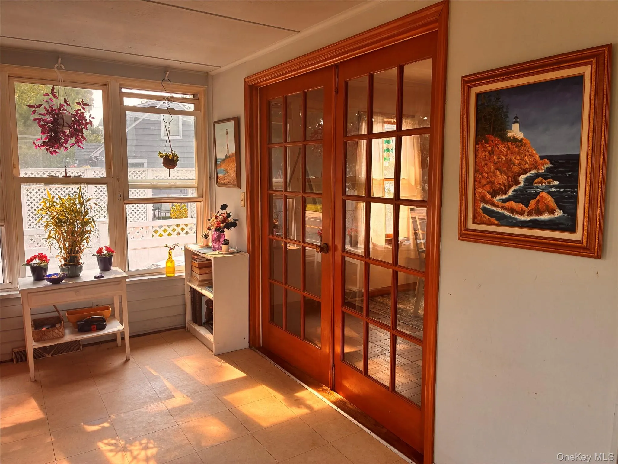 Sunroom featuring light-colored flooring, multiple windows, and a lattice fence exterior Sunroom featuring light-colored flooring, multiple windows, and a lattice fence exterior
