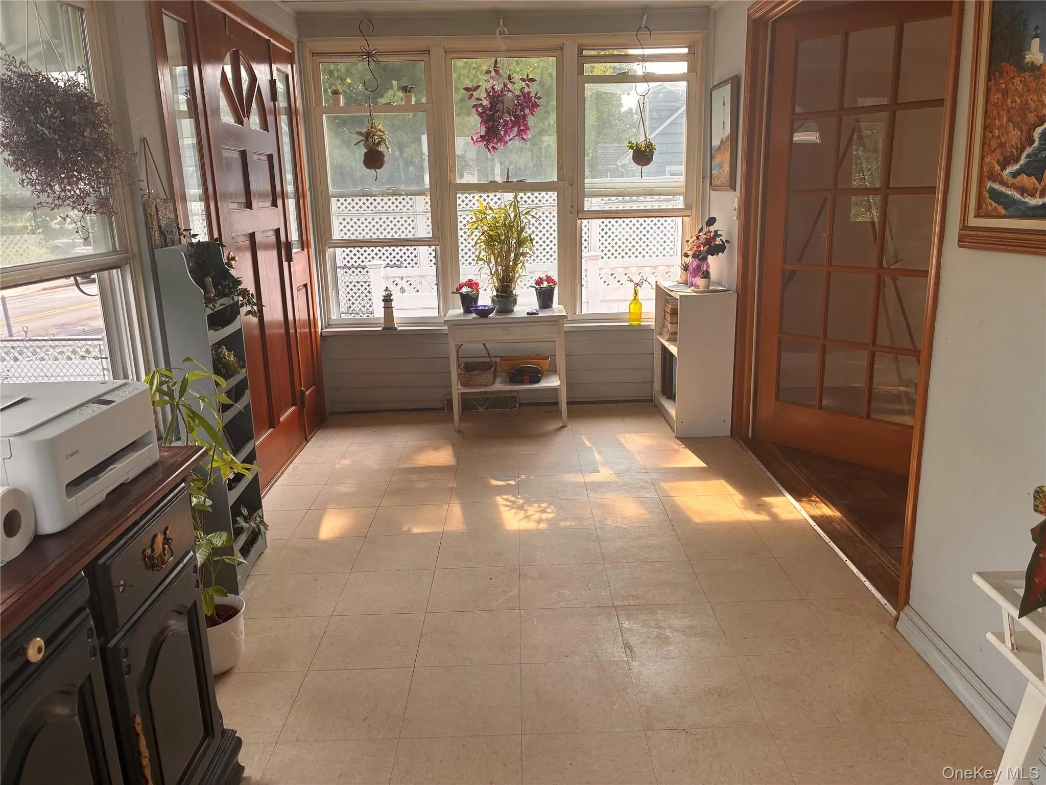 Enclosed sunroom featuring multiple windows, paneled wood door, and a glass-paneled wood door Enclosed sunroom featuring multiple windows, paneled wood door, and a glass-paneled wood door