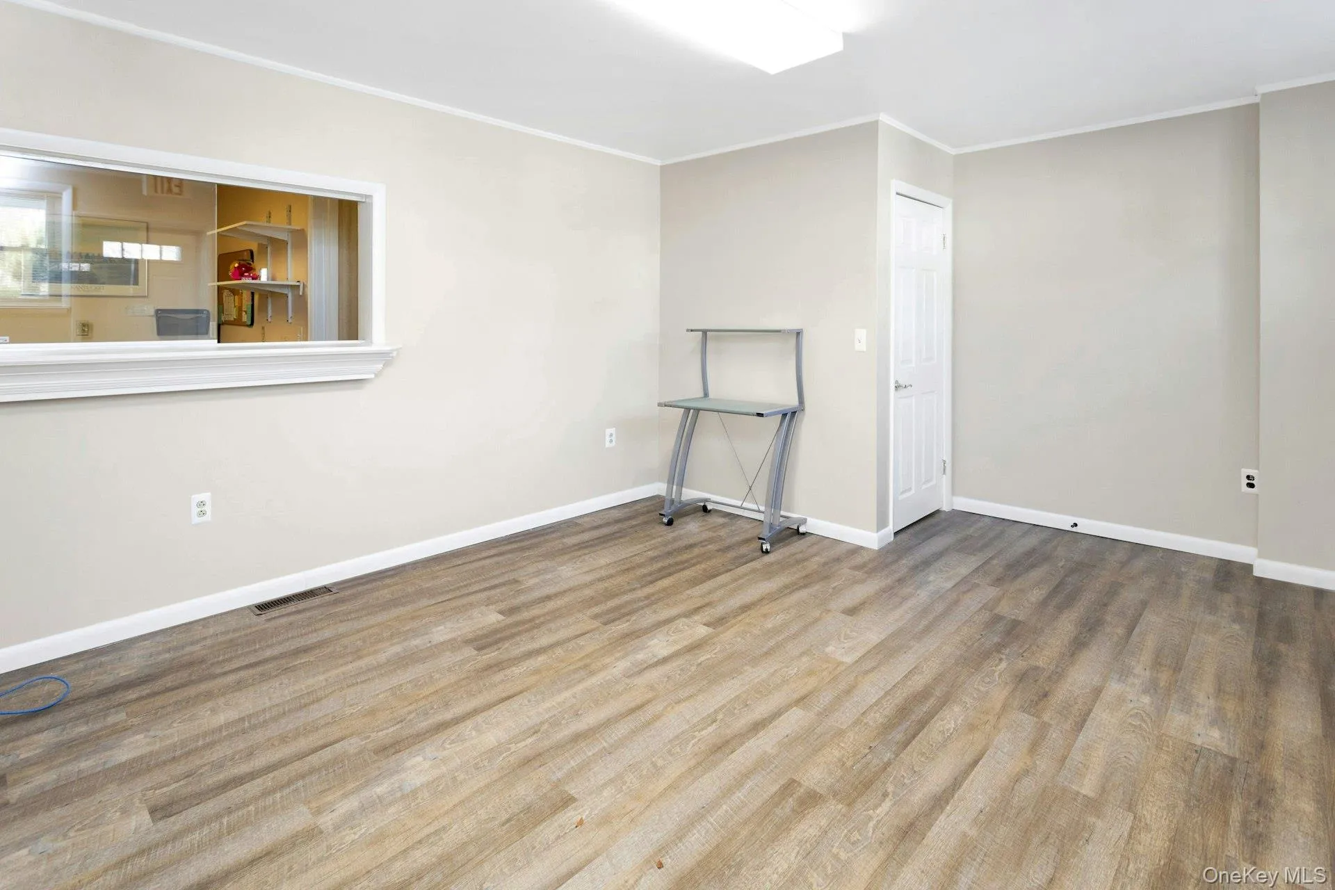 Spare room with hardwood / wood-style floors and ornamental molding Spare room with hardwood / wood-style floors and ornamental molding
