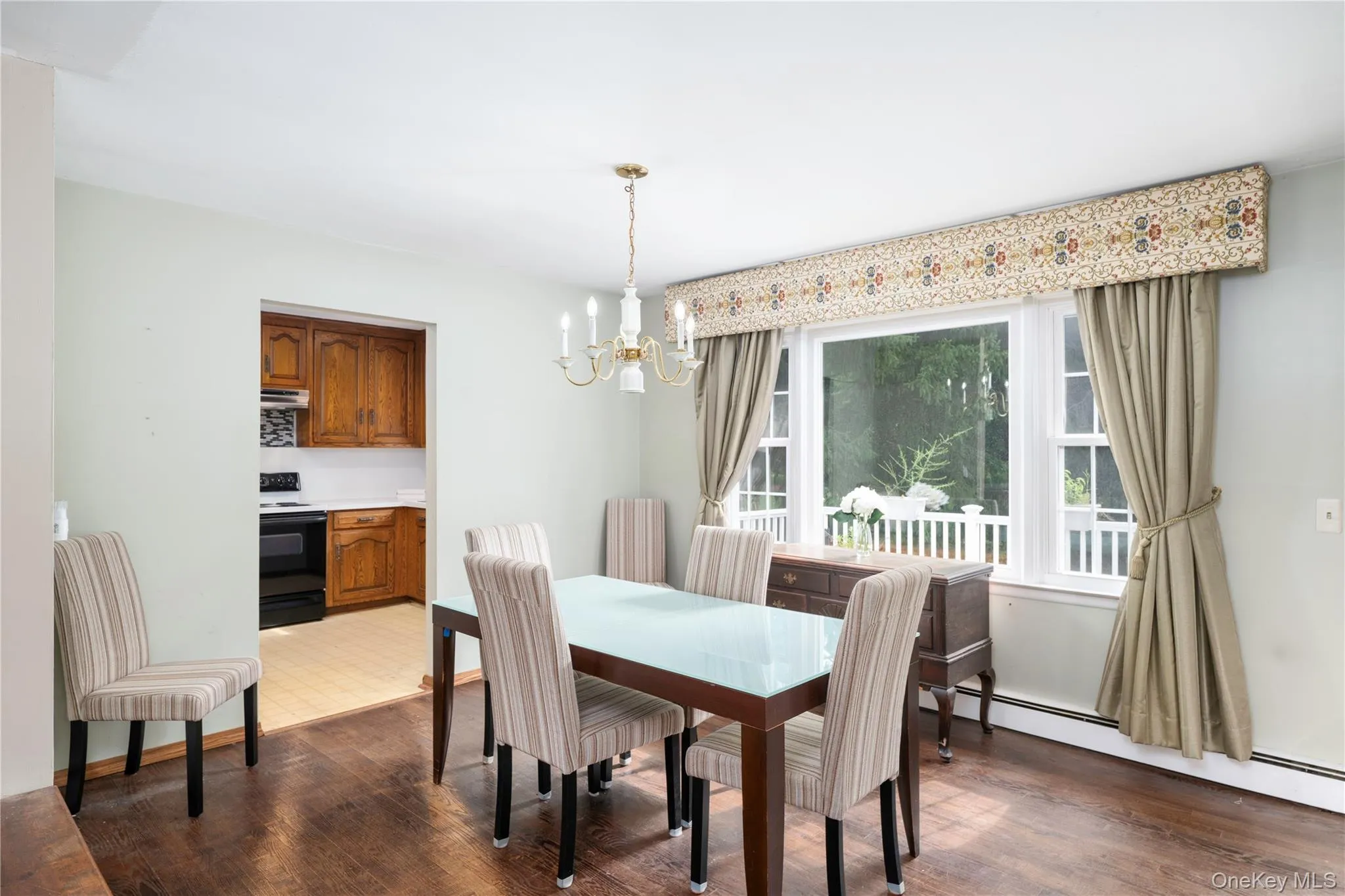 Hardwood flooring, white walls, and a multi-pane window with white trim Hardwood flooring, white walls, and a multi-pane window with white trim