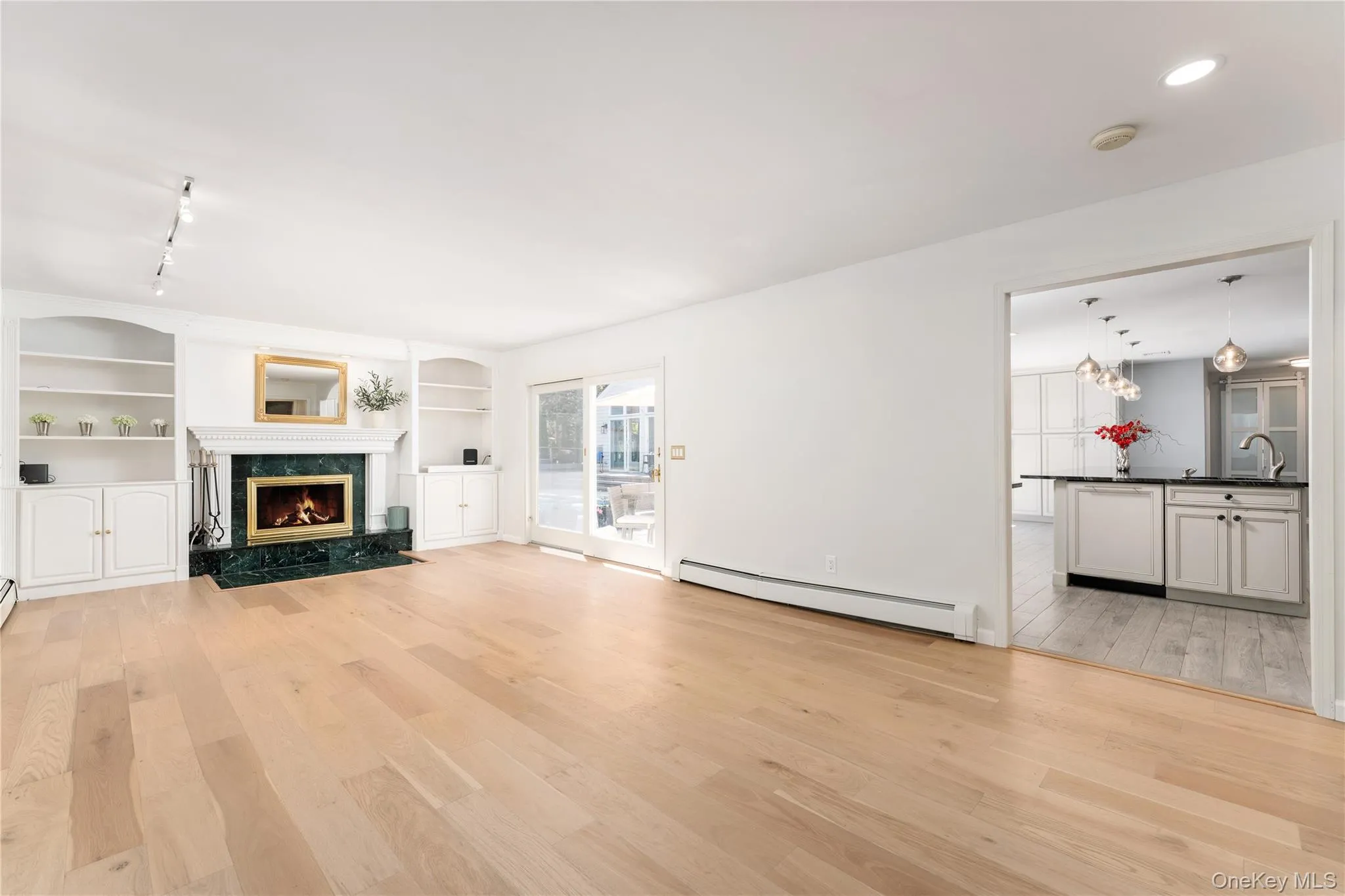 Wood-burning fireplace, built-in bookcases, sliding door to patio, overhead lighting Wood-burning fireplace, built-in bookcases, sliding door to patio, overhead lighting