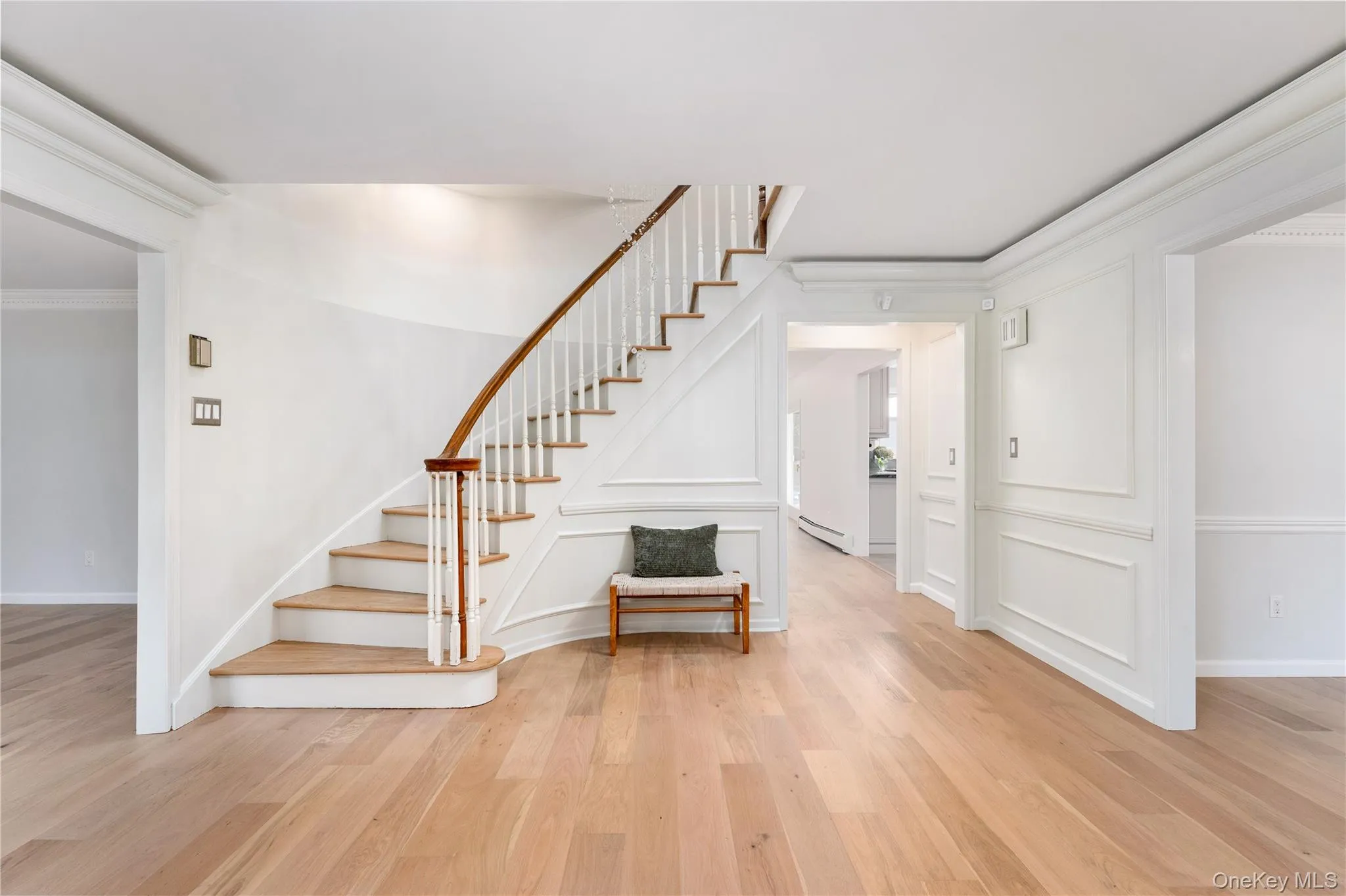 Front hall entry, custom millwork, new flooring, accent lighting, sweeping staircase Front hall entry, custom millwork, new flooring, accent lighting, sweeping staircase