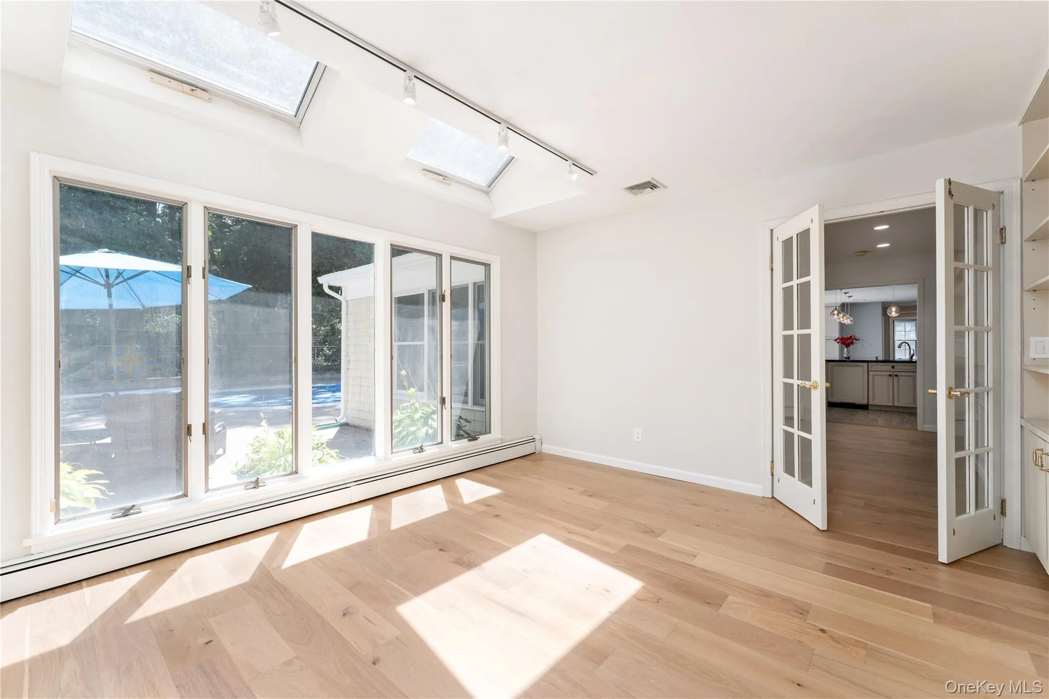 Oversized windows overlooking patio, skylights Oversized windows overlooking patio, skylights