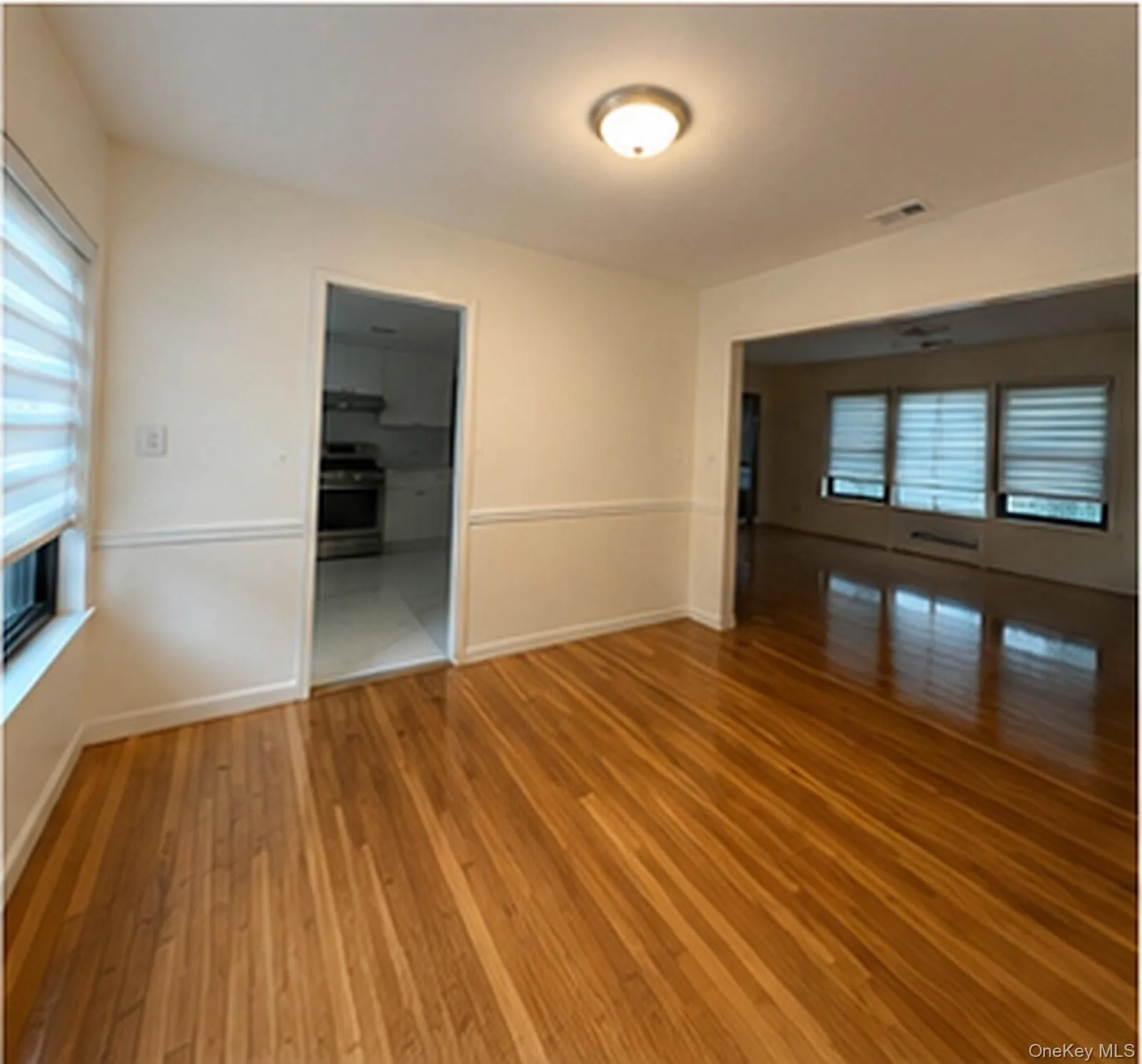 Hardwood flooring throughout, chair rail molding, and recessed lighting Hardwood flooring throughout, chair rail molding, and recessed lighting
