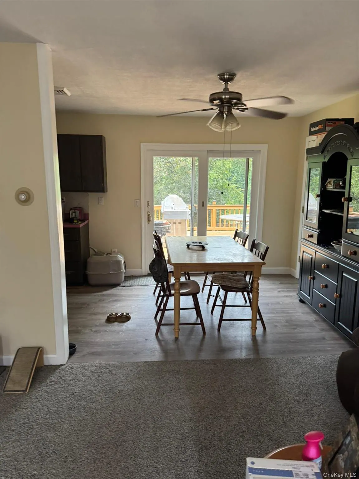 Dining area with a ceiling fan and light wood-style flooring Dining area with a ceiling fan and light wood-style flooring