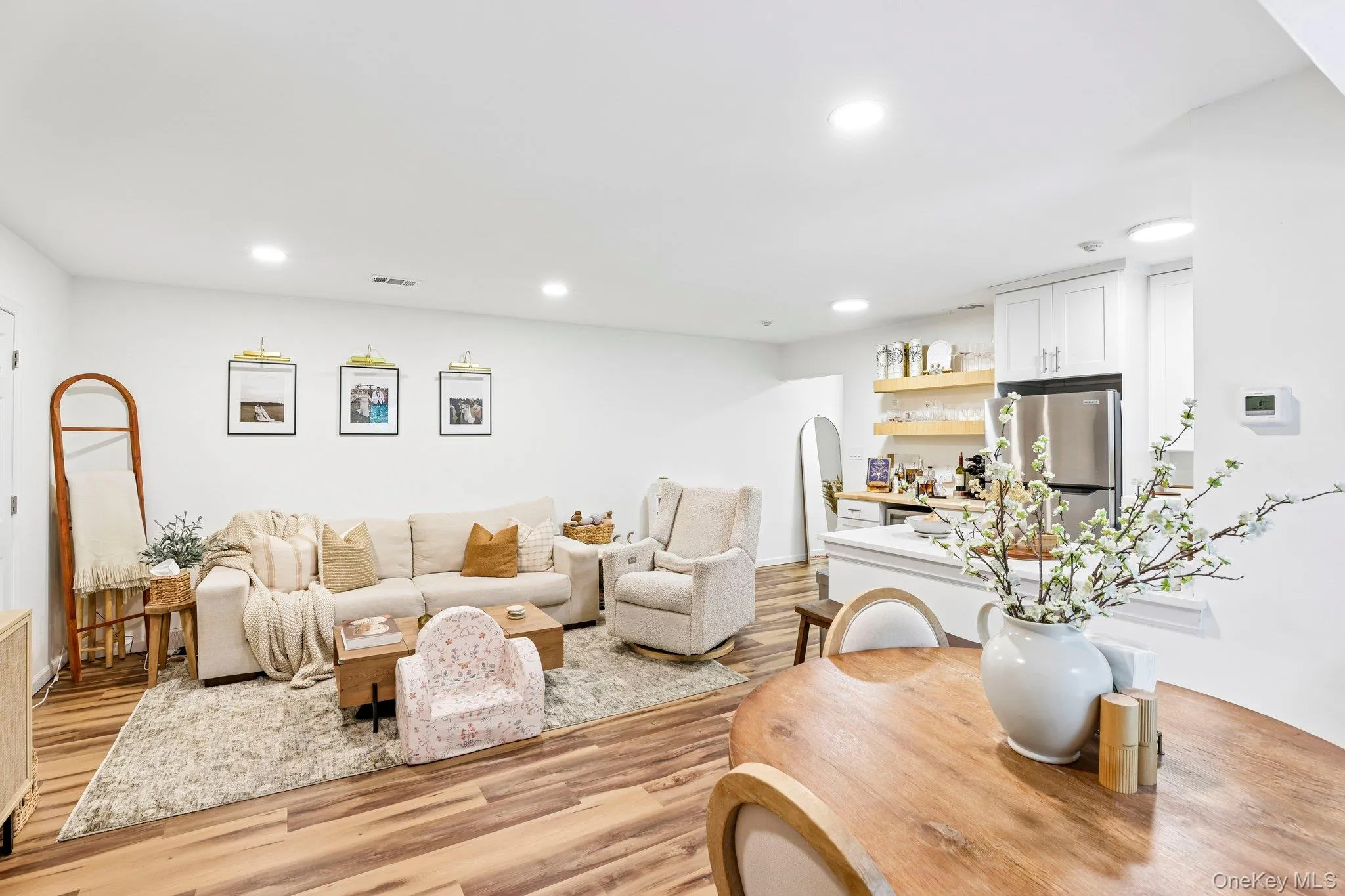 Flowing effortlessly from the kitchen, the welcoming living room offers a comfortable setting for relaxing and entertaining Flowing effortlessly from the kitchen, the welcoming living room offers a comfortable setting for relaxing and entertaining