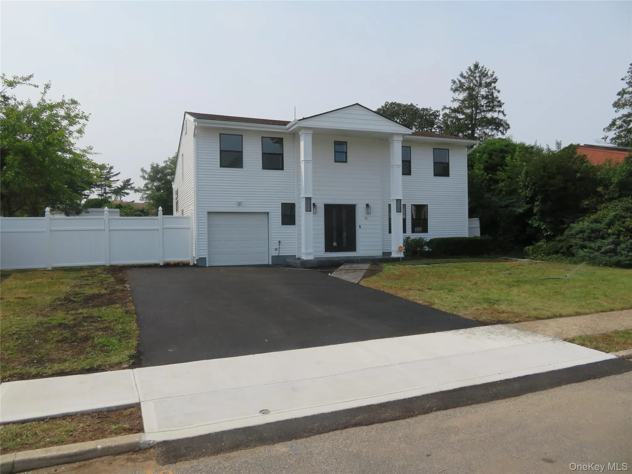 White siding exterior with a prominent two-story portico White siding exterior with a prominent two-story portico