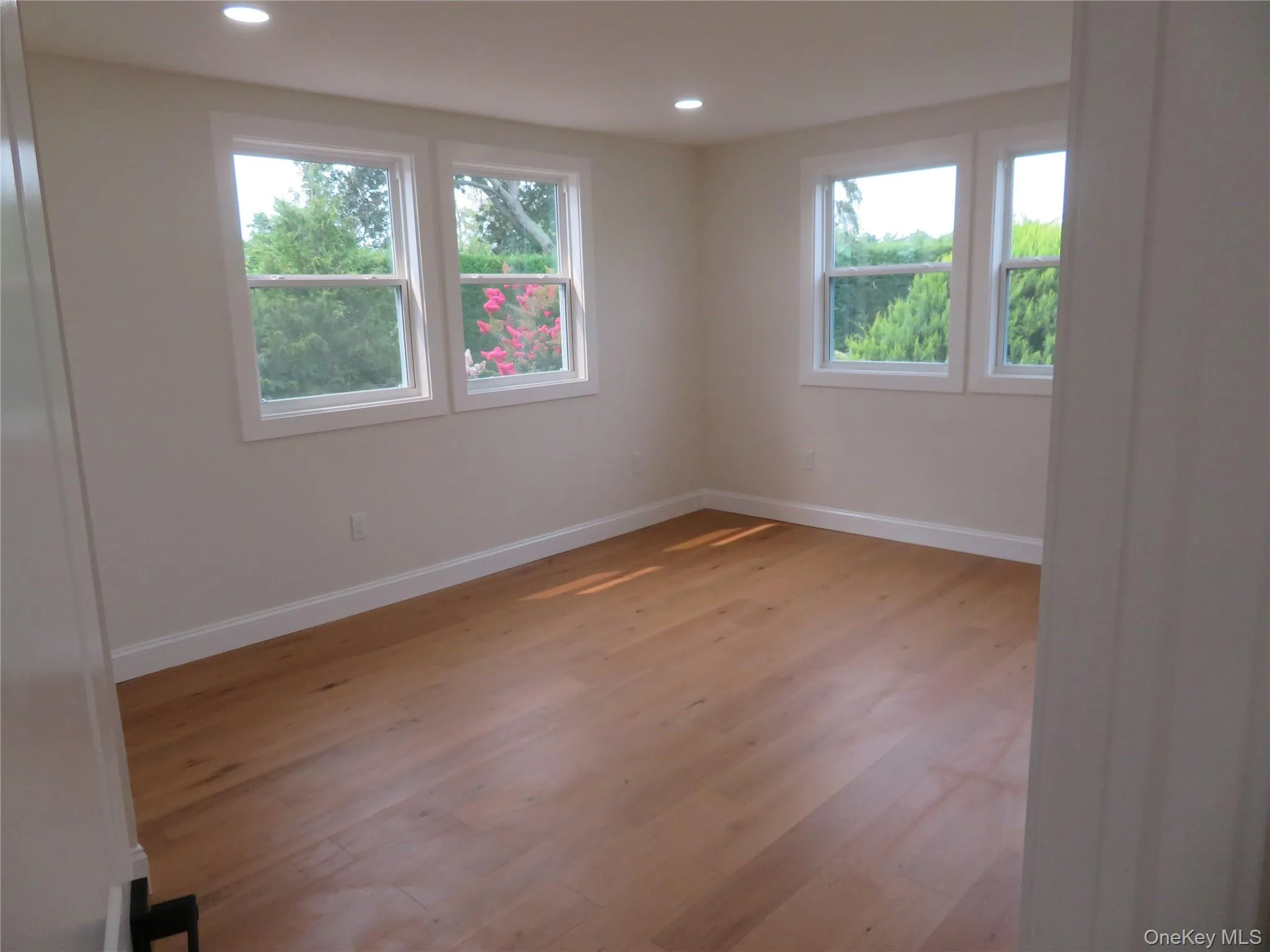 Recessed lighting illuminating wood-finish flooring Recessed lighting illuminating wood-finish flooring