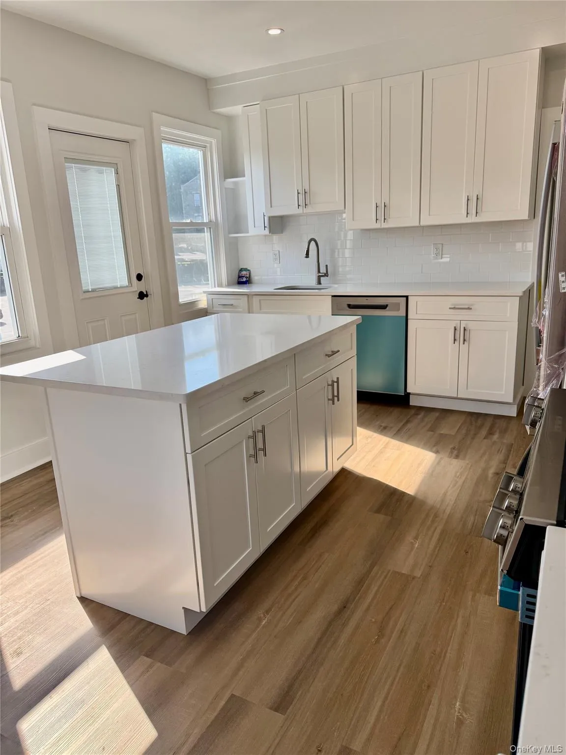 Kitchen with wall of windows and door to egress balcony Kitchen with wall of windows and door to egress balcony