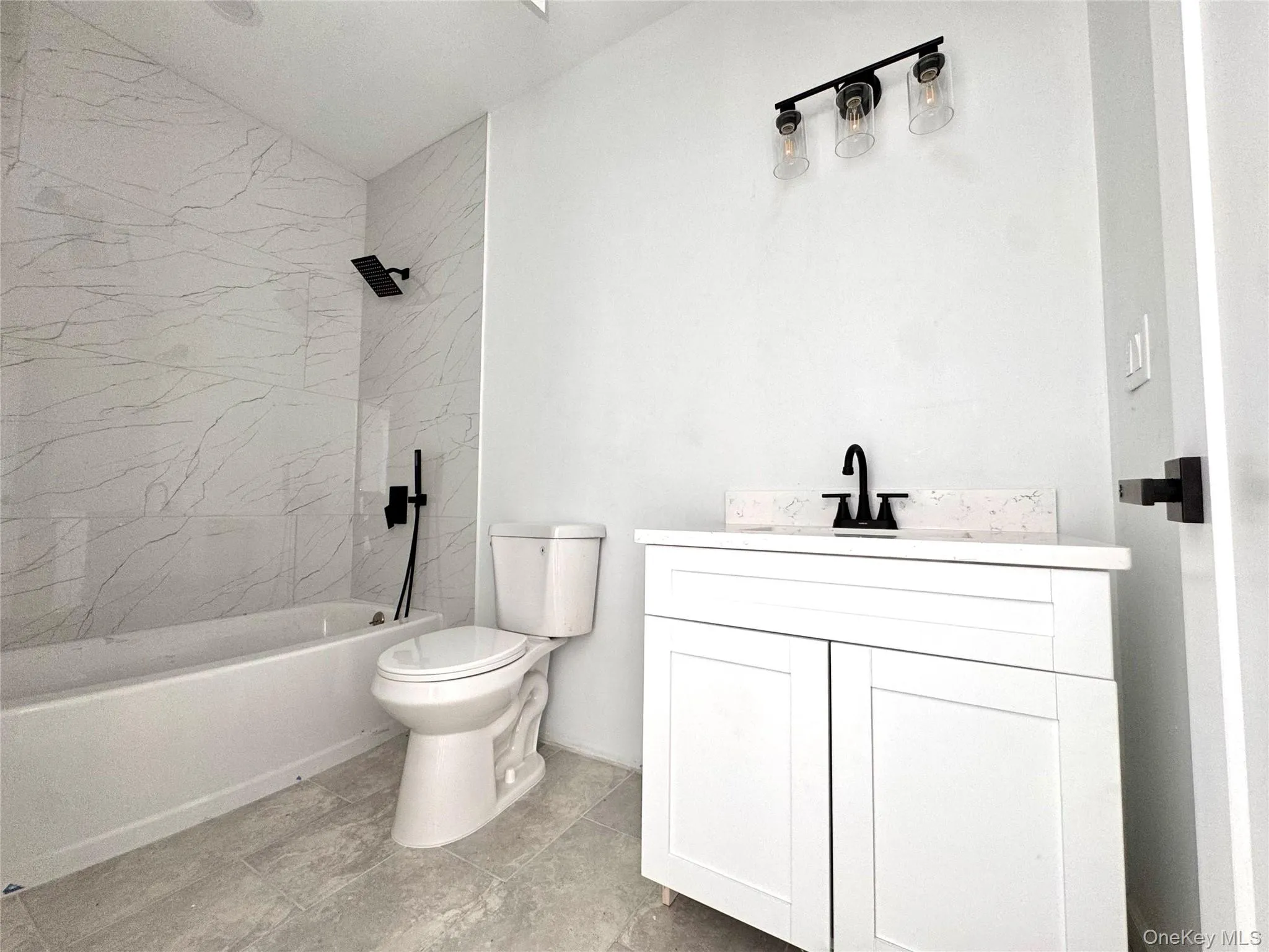 Full Bathroom featuring a bathtub with rainforest shower Full Bathroom featuring a bathtub with rainforest shower