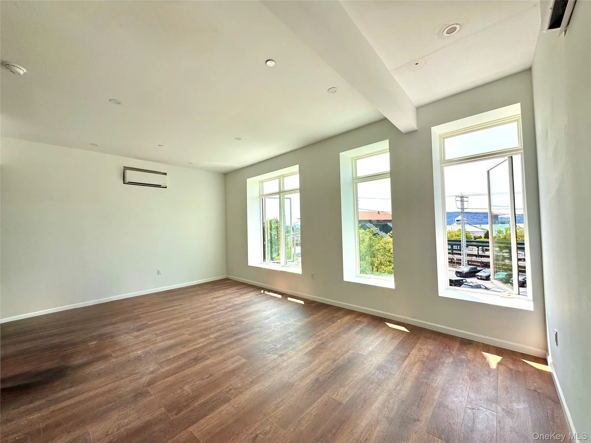 Living Room/Dining Room combo featuring large windows and ductless AC unit Living Room/Dining Room combo featuring large windows and ductless AC unit