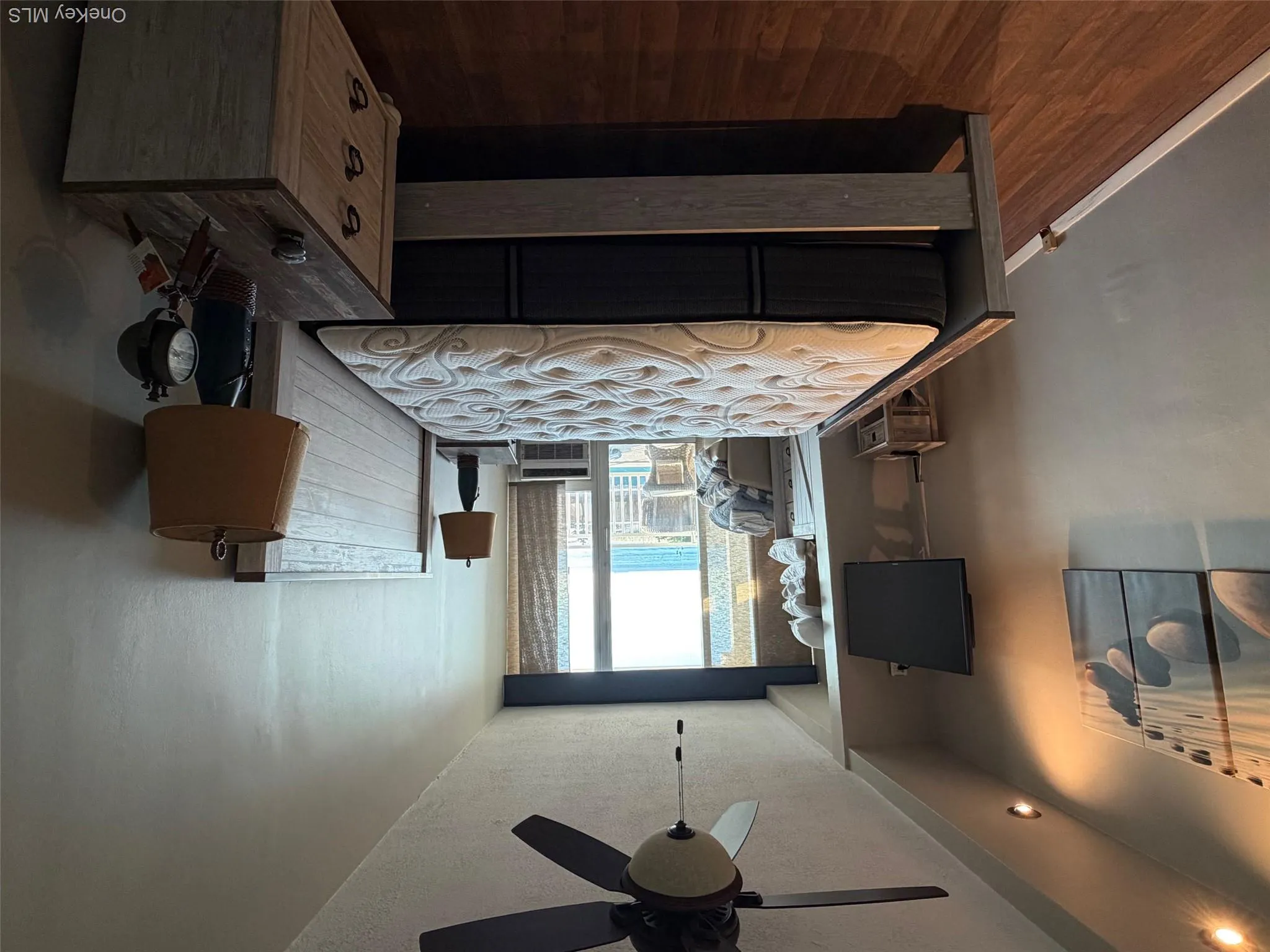 Bedroom featuring dark wood-style floors, access to outside, ceiling fan, and a textured ceiling Bedroom featuring dark wood-style floors, access to outside, ceiling fan, and a textured ceiling