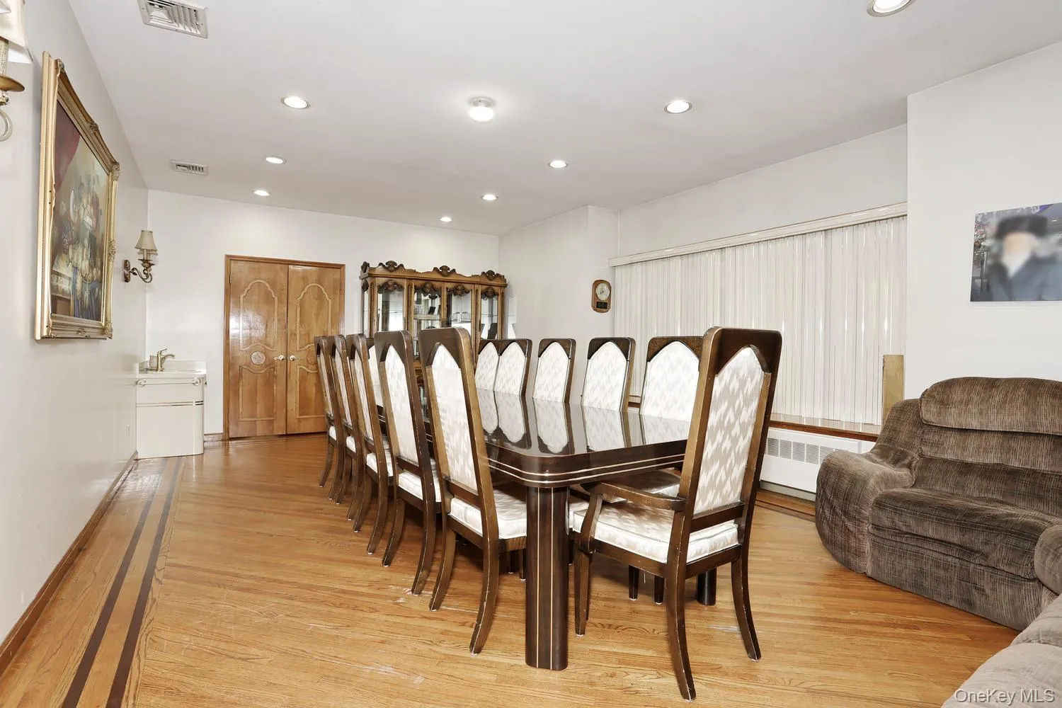 Hardwood flooring with inlay detailing, recessed lighting, and a window with blinds Hardwood flooring with inlay detailing, recessed lighting, and a window with blinds