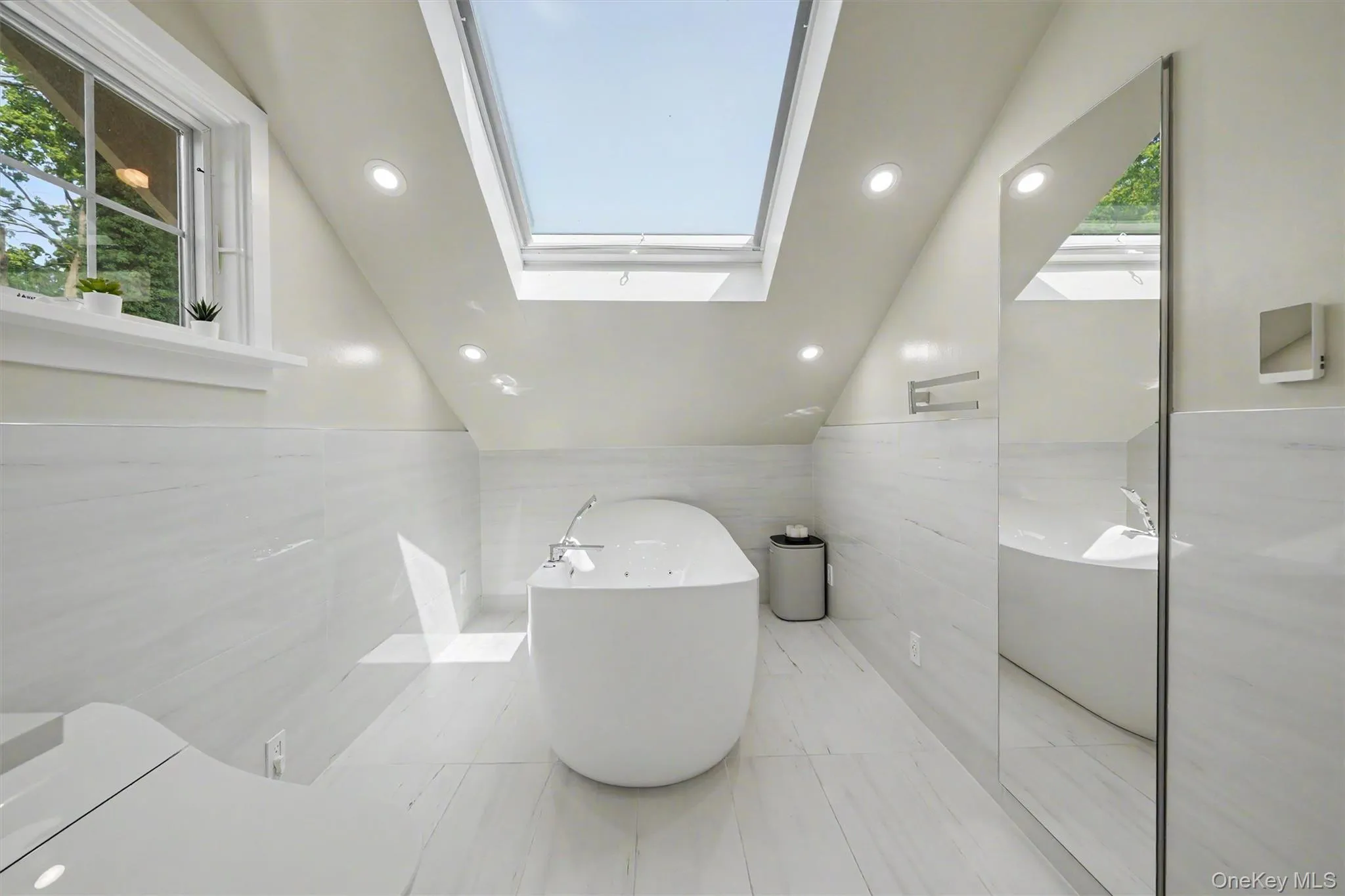 Beautifully updated full bathroom with skylight and Woodbridge soaking tub & Kohler toilet Beautifully updated full bathroom with skylight and Woodbridge soaking tub & Kohler toilet