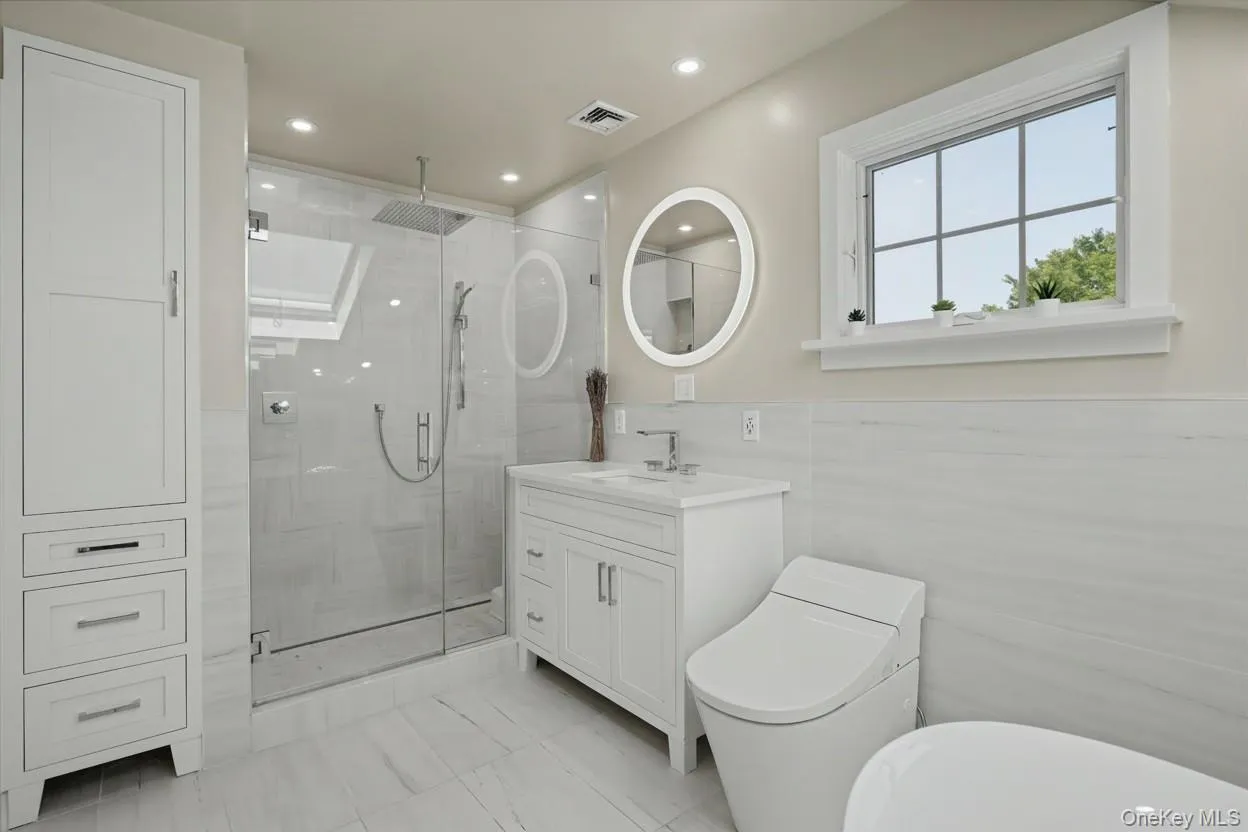 Beautifully updated full bathroom with skylight and Woodbridge soaking tub & Kohler toilet Beautifully updated full bathroom with skylight and Woodbridge soaking tub & Kohler toilet