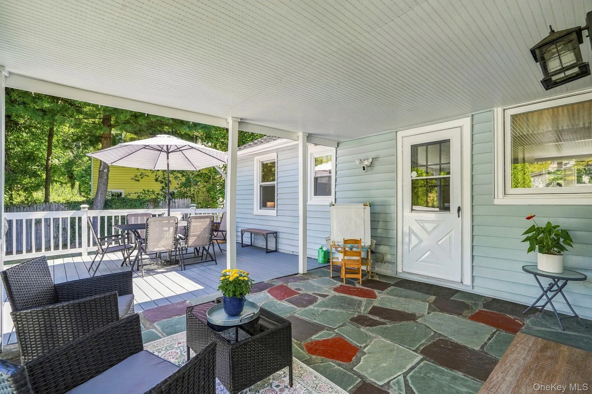 Step outside to the attached covered patio, creating acomfortable three-season space that flows naturally to the expansive deck - perfect for relaxing and enjoying the outdoors. Step outside to the attached covered patio, creating acomfortable three-season space that flows naturally to the expansive deck - perfect for relaxing and enjoying the outdoors.