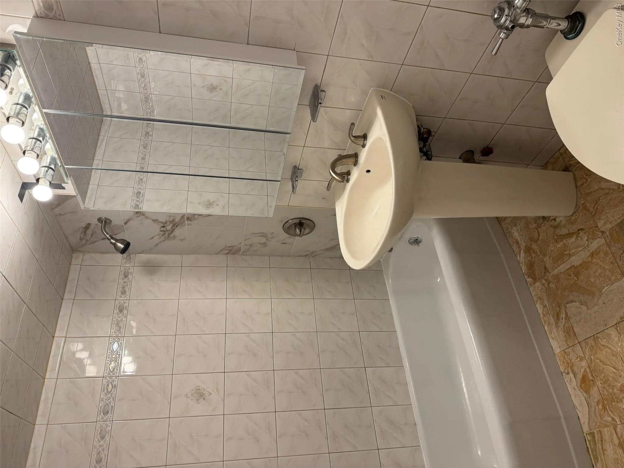 Full bath featuring tile walls, shower / washtub combination, and backsplash Full bath featuring tile walls, shower / washtub combination, and backsplash