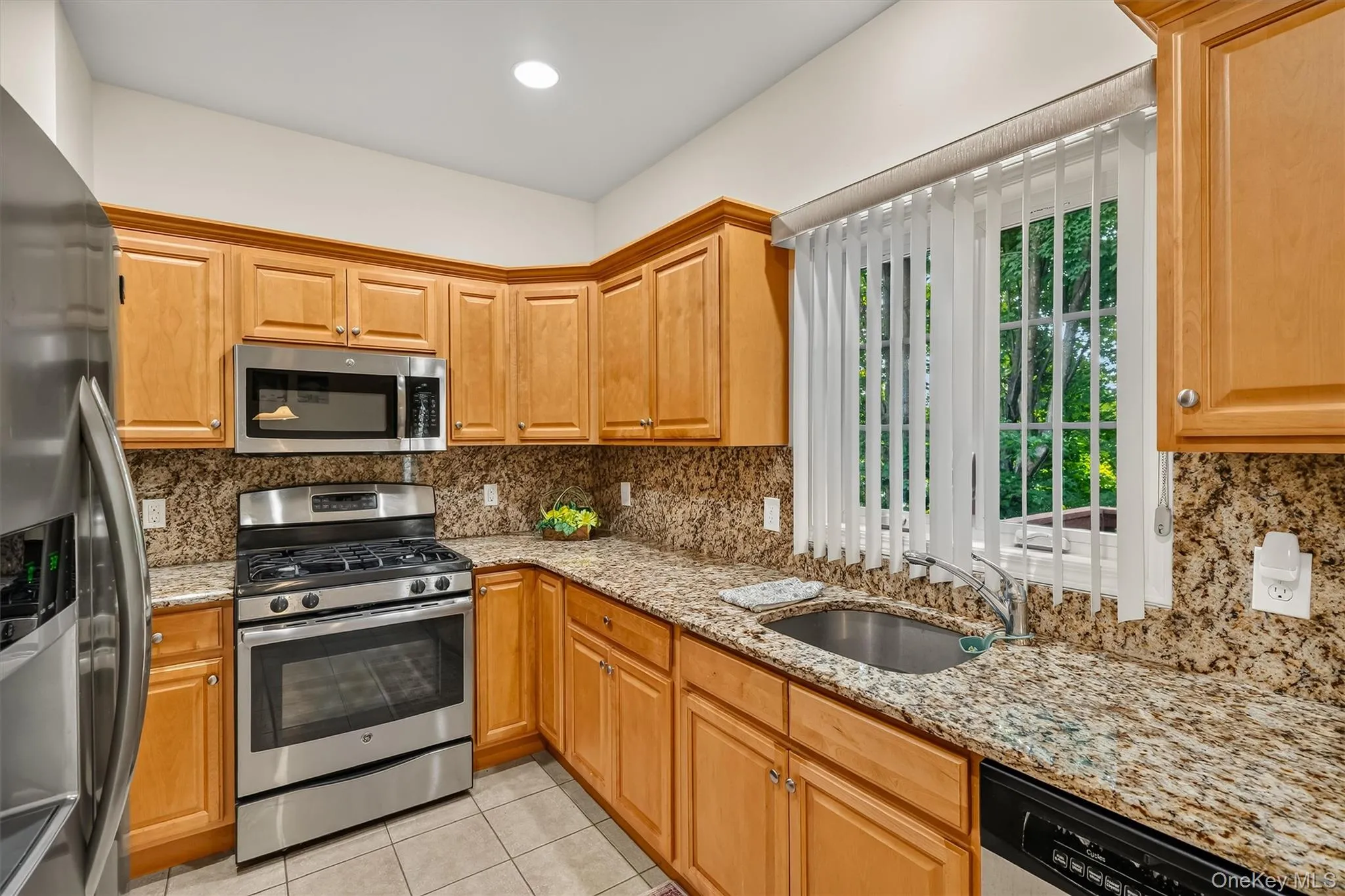 The kitchen has a large window above the sink overlooking the back yard. The kitchen has a large window above the sink overlooking the back yard.