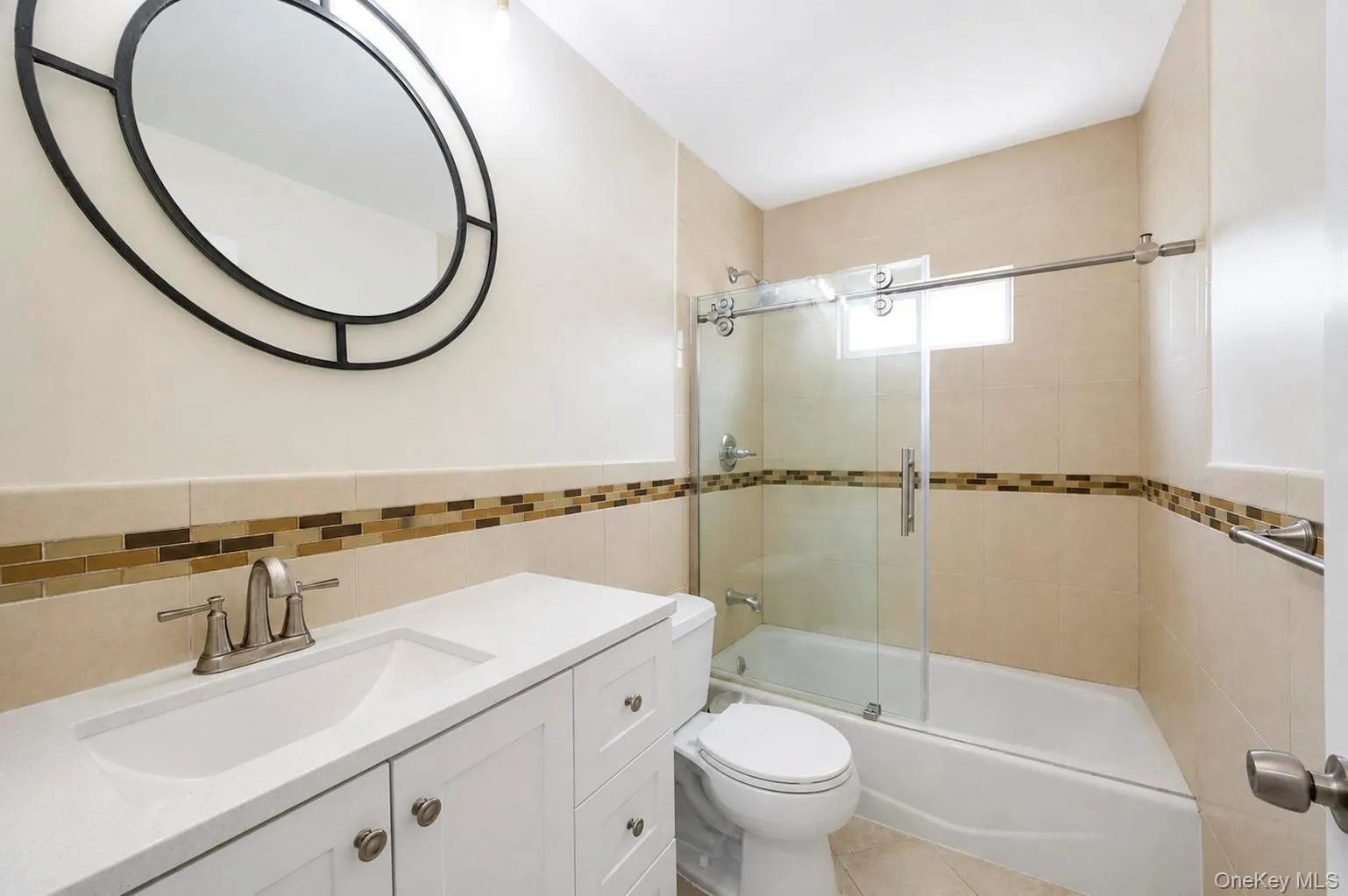 White vanity with a built-in sink, brushed nickel faucet, and a large wall mirror White vanity with a built-in sink, brushed nickel faucet, and a large wall mirror