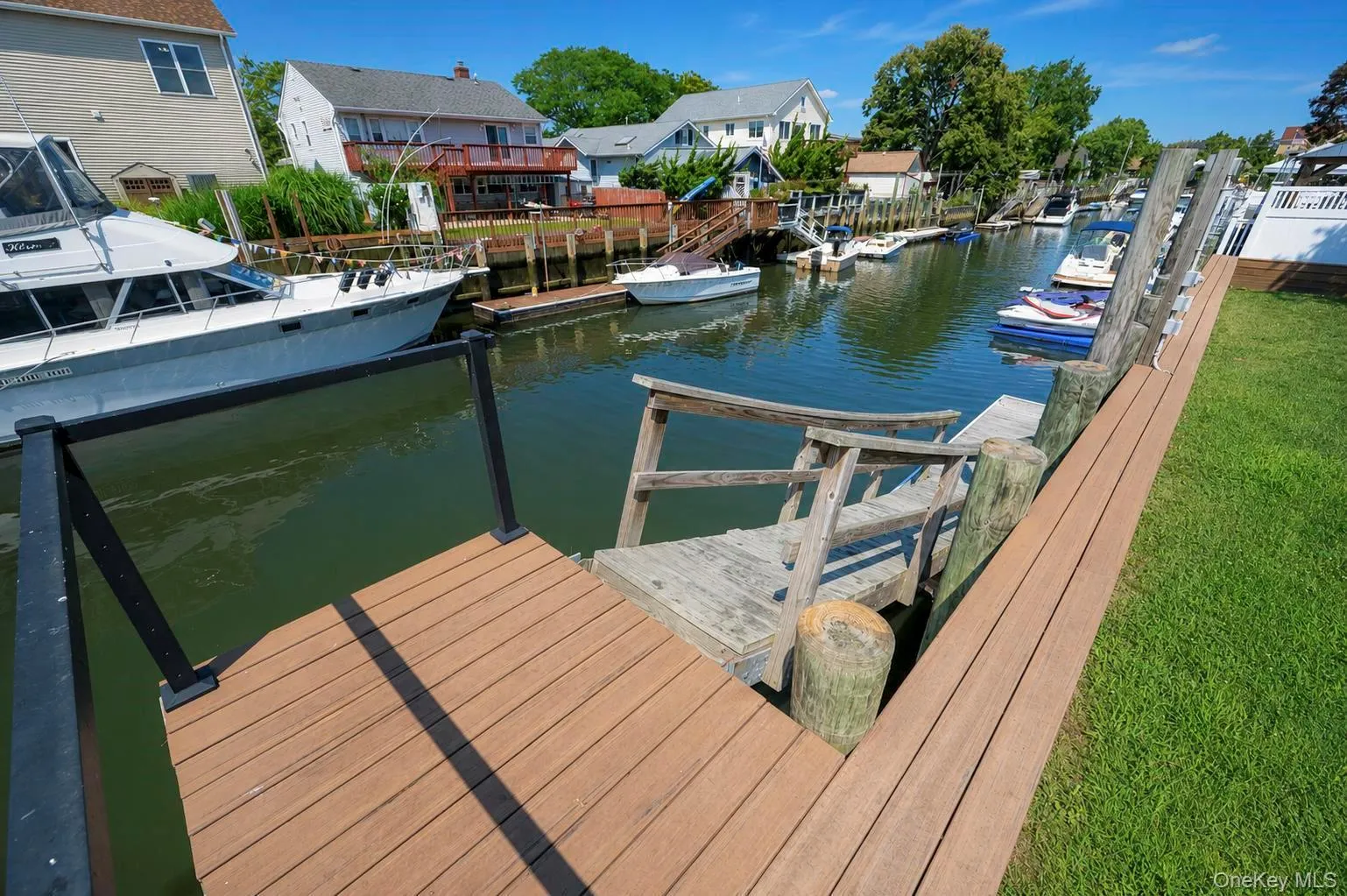 Waterfront property featuring a composite deck, direct water access, and a wooden dock Waterfront property featuring a composite deck, direct water access, and a wooden dock