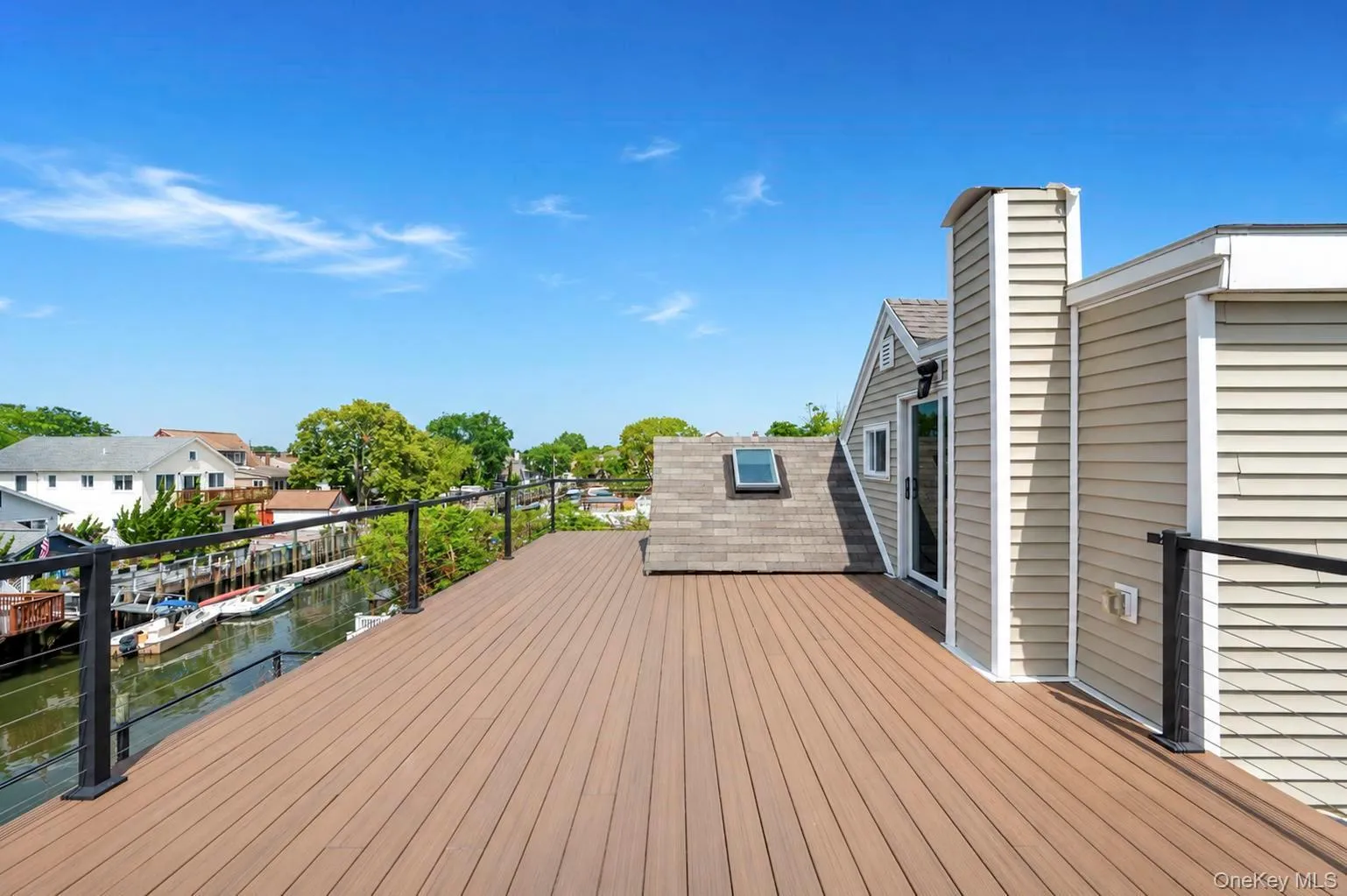 Expansive rooftop deck featuring composite decking and black metal railings Expansive rooftop deck featuring composite decking and black metal railings