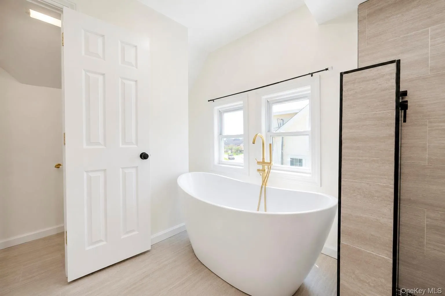 Freestanding soaking tub with a gold-tone floor-mounted filler Freestanding soaking tub with a gold-tone floor-mounted filler