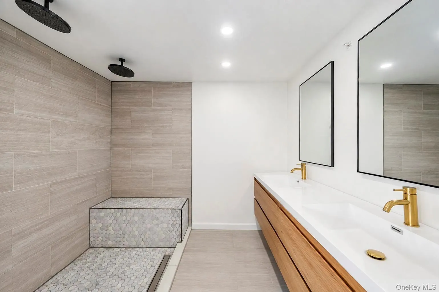 Dual vanity with integrated sinks and gold-finish fixtures Dual vanity with integrated sinks and gold-finish fixtures