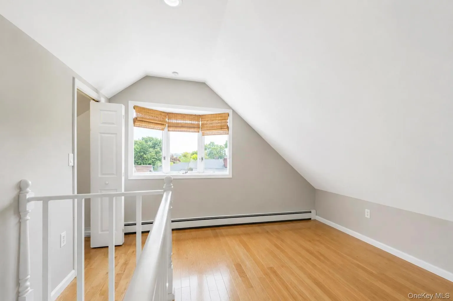 Recessed lighting, wood-finish flooring, bay window, white painted railing, and built-in heat registers Recessed lighting, wood-finish flooring, bay window, white painted railing, and built-in heat registers