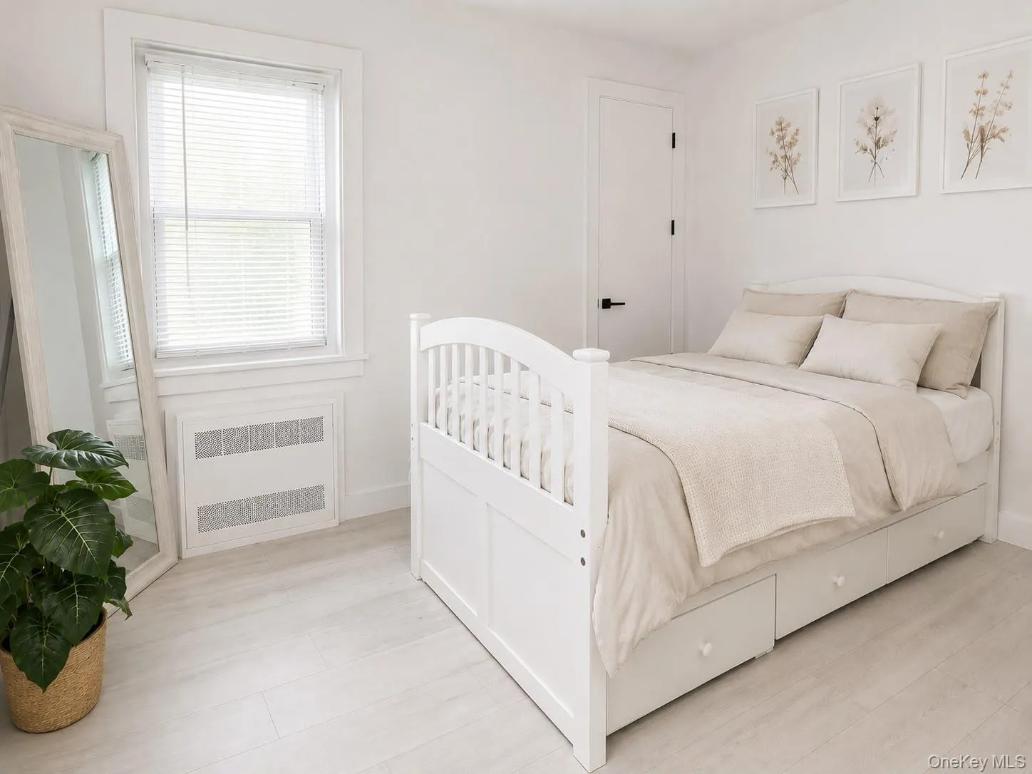 White wood-finish flooring with a white door and dark hardware White wood-finish flooring with a white door and dark hardware