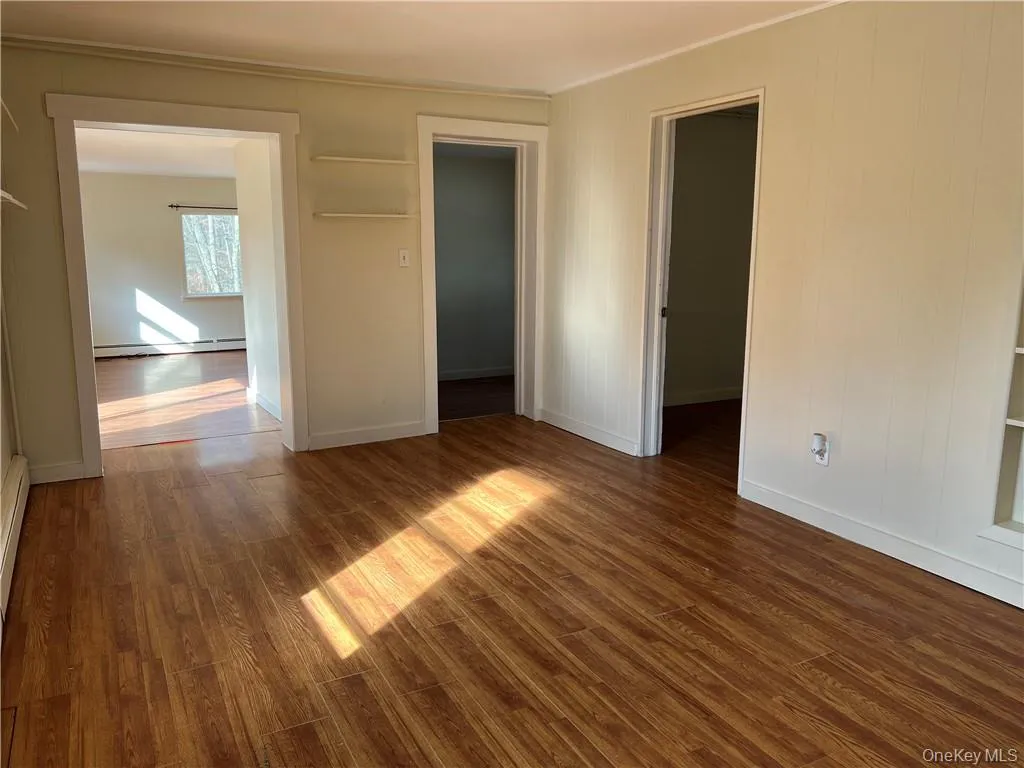 Dining area with baseboard heating unit and dark hardwood / wood-style floors Dining area with baseboard heating unit and dark hardwood / wood-style floors