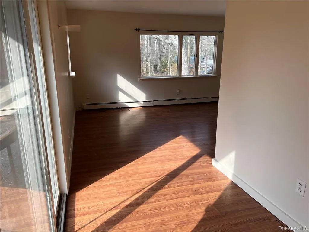 Opening to living room with sliding doors. Opening to living room with sliding doors.