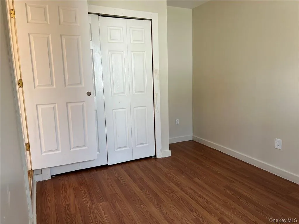 Bedroom #1 with dark hardwood / wood-style floors and a closet Bedroom #1 with dark hardwood / wood-style floors and a closet