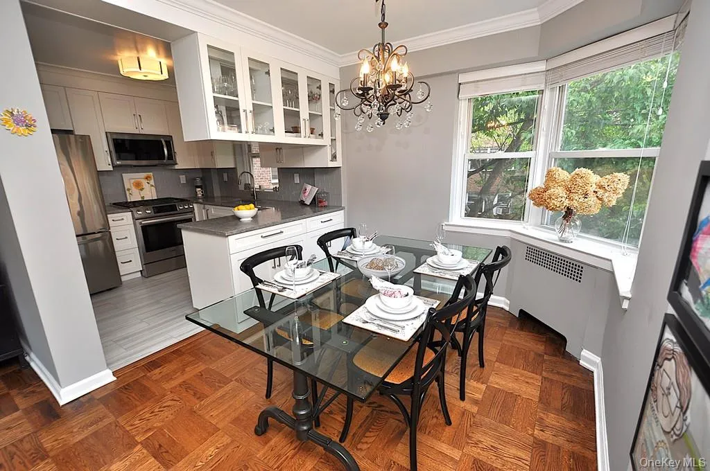 The dining area has a bay window and opens to both the living room and renovated kitchen. The dining room is approx 9'-0" x 8'-10" The dining area has a bay window and opens to both the living room and renovated kitchen. The dining room is approx 9'-0" x 8'-10"
