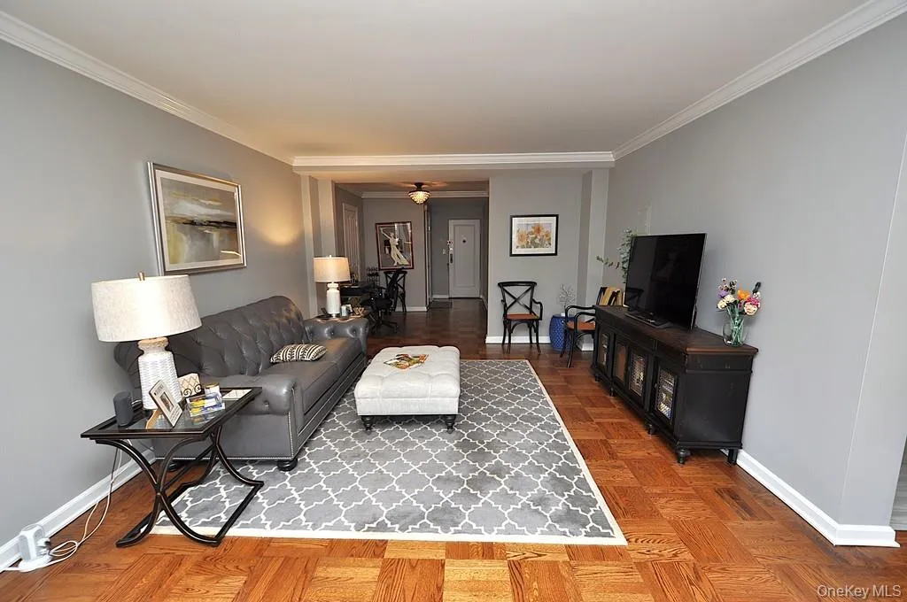 The large living room has refinished parquet floors, a bay window and opens to both the dining room and foyer. The living room is approx 21'-5' x 12'-6" . The large living room has refinished parquet floors, a bay window and opens to both the dining room and foyer. The living room is approx 21'-5' x 12'-6" .